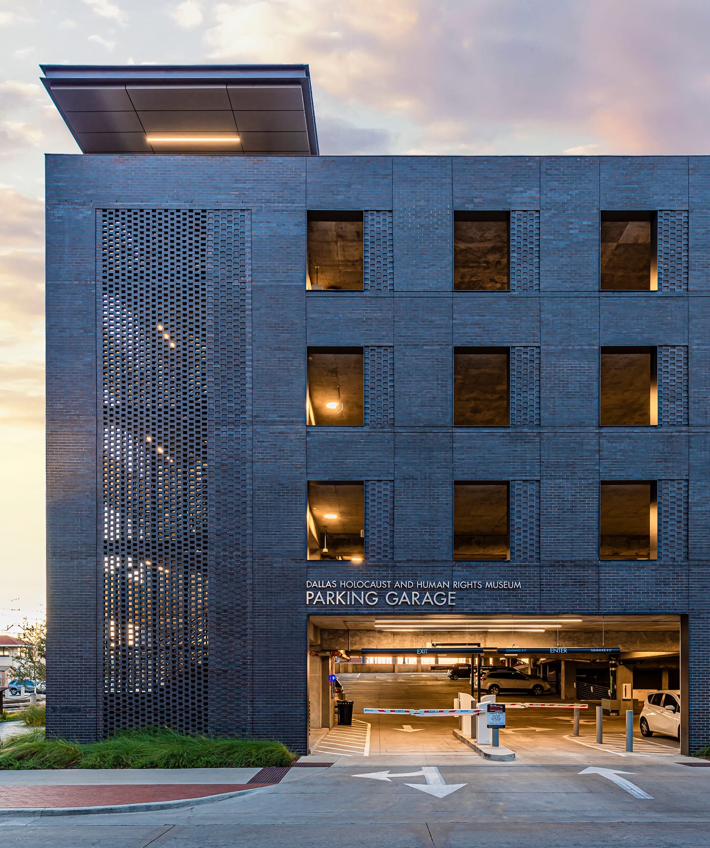 Parking garage entrance signage with perforated brick facade at Dallas Holocaust and Human Rights Museum - environmental graphic design and wayfinding by RSM Design