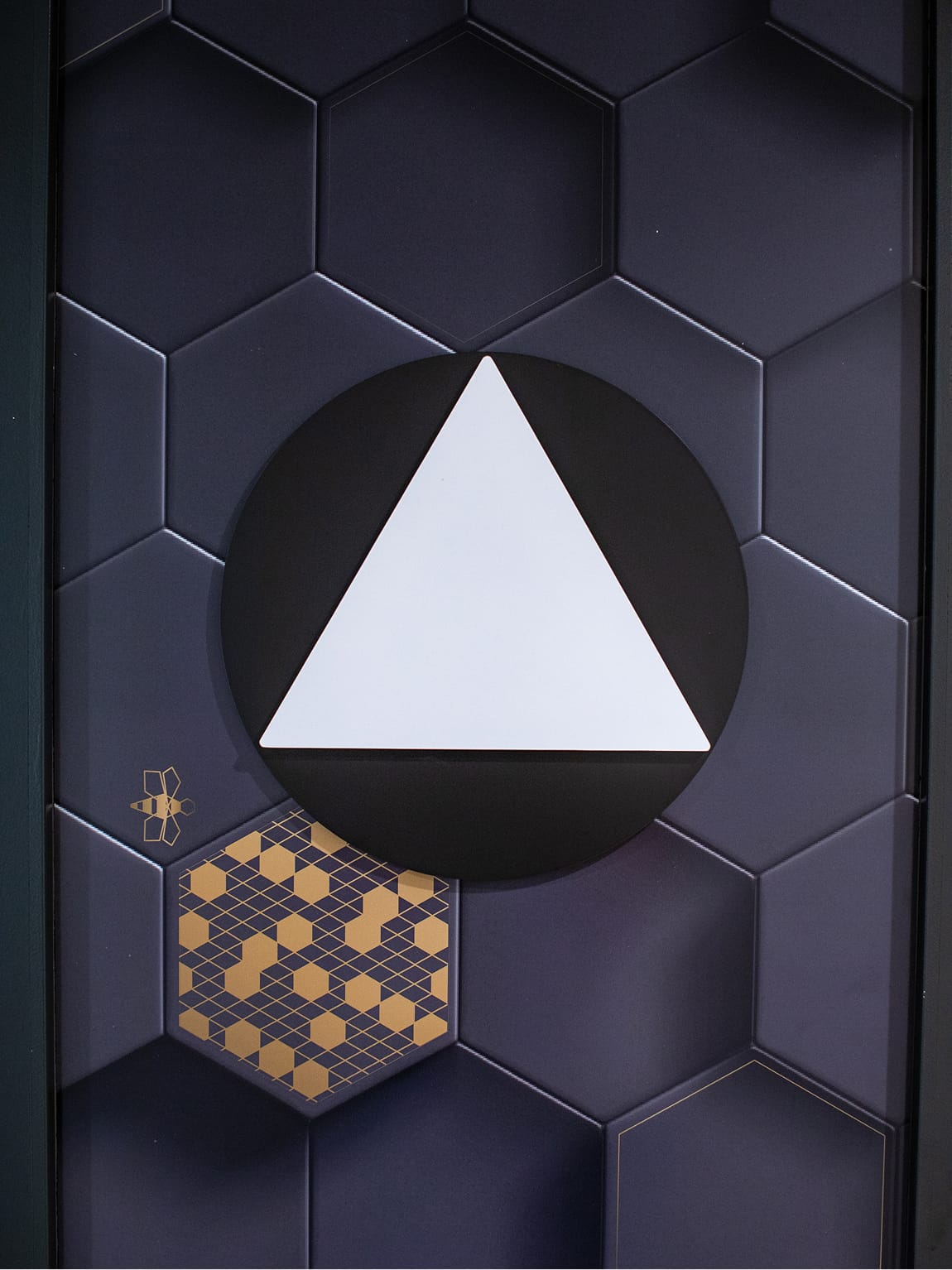 Persea residential community elevator direction signage with hexagonal pattern and bee icon, environmental graphic design by RSM Design