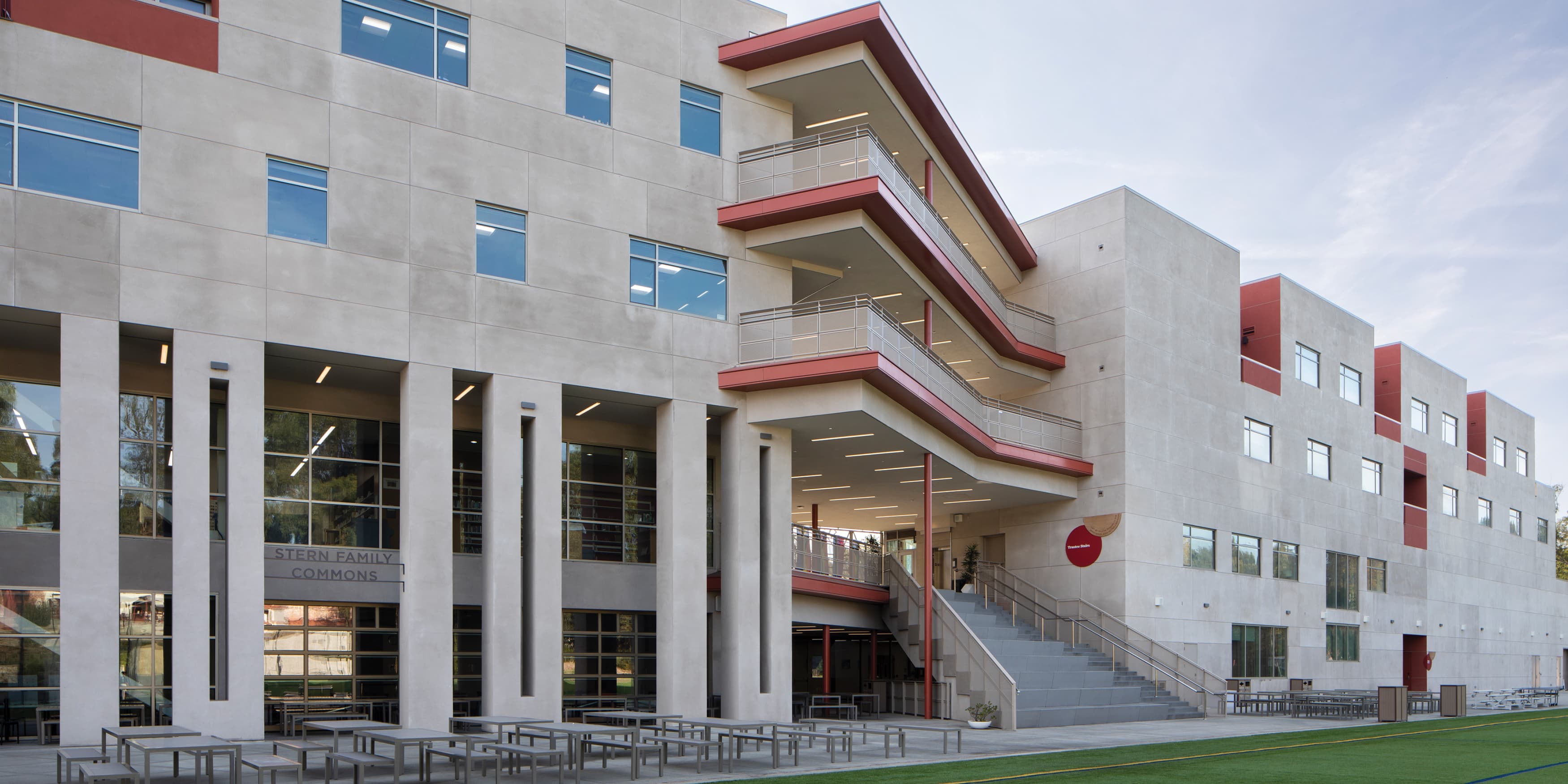 Daytime shot of exterior of Brentwood School in Los Angeles. Modern, contemporary architecture matched with red detailing and signage. 