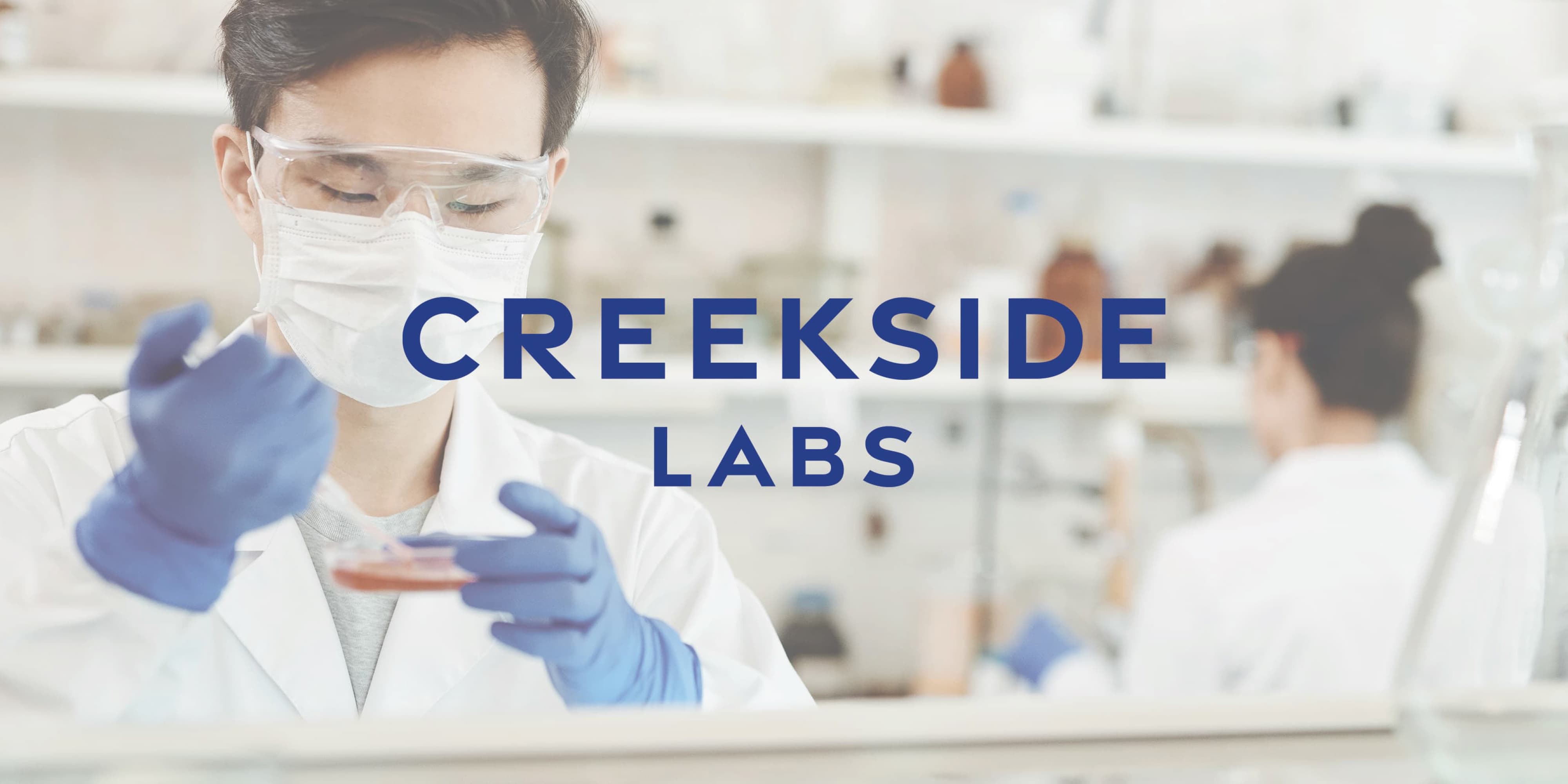 Scientists working in a life science laboratory at Creekside Labs, illustrating workplace branding, environmental graphic design, and placemaking for research campuses and innovation districts in Sorrento Valley.