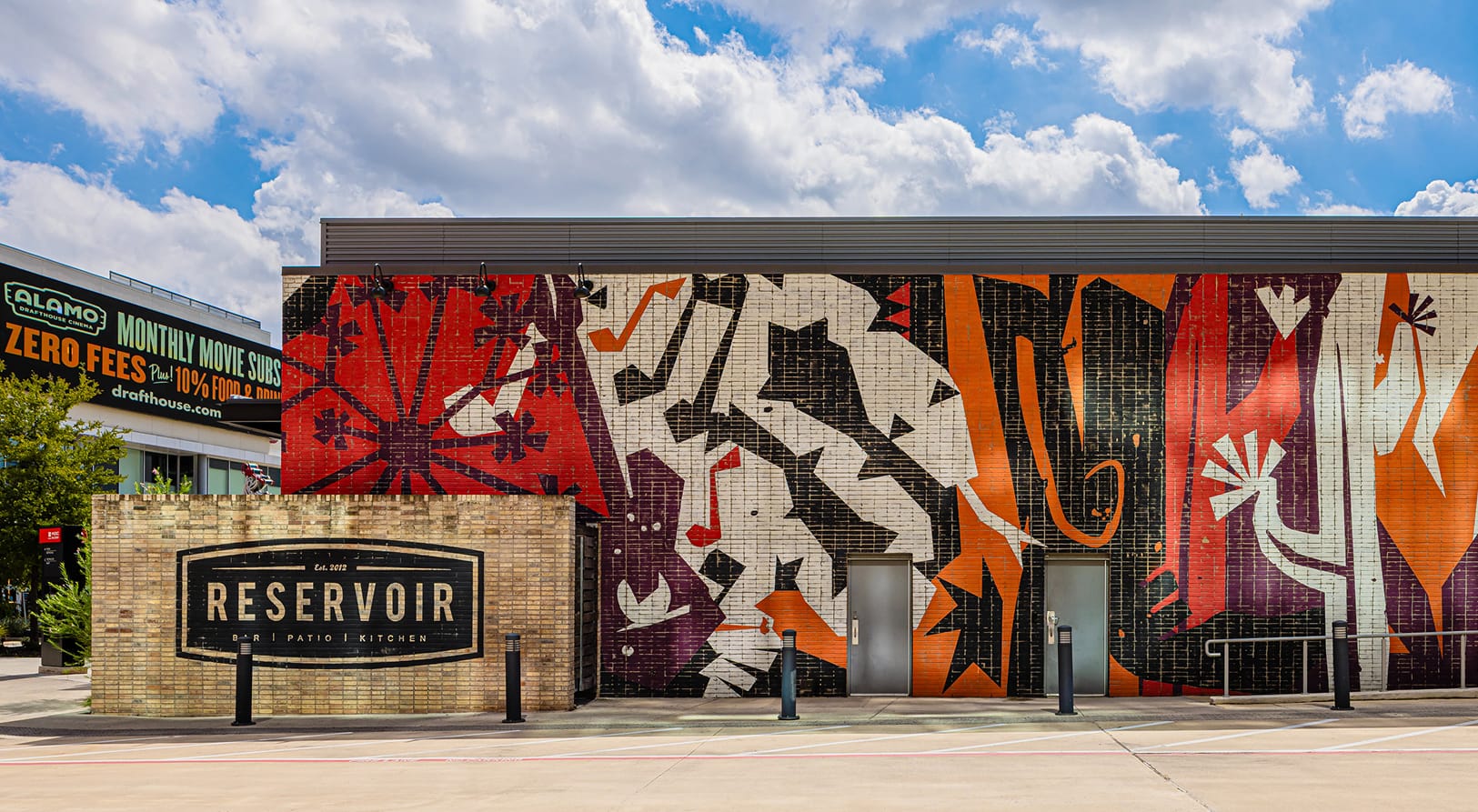Large-format exterior mural and tenant identification signage for Reservoir Bar at Toyota Music Factory — public art, murals, experiential graphics, and branded environmental design for mixed-use, food and beverage, and streetscape destinations.