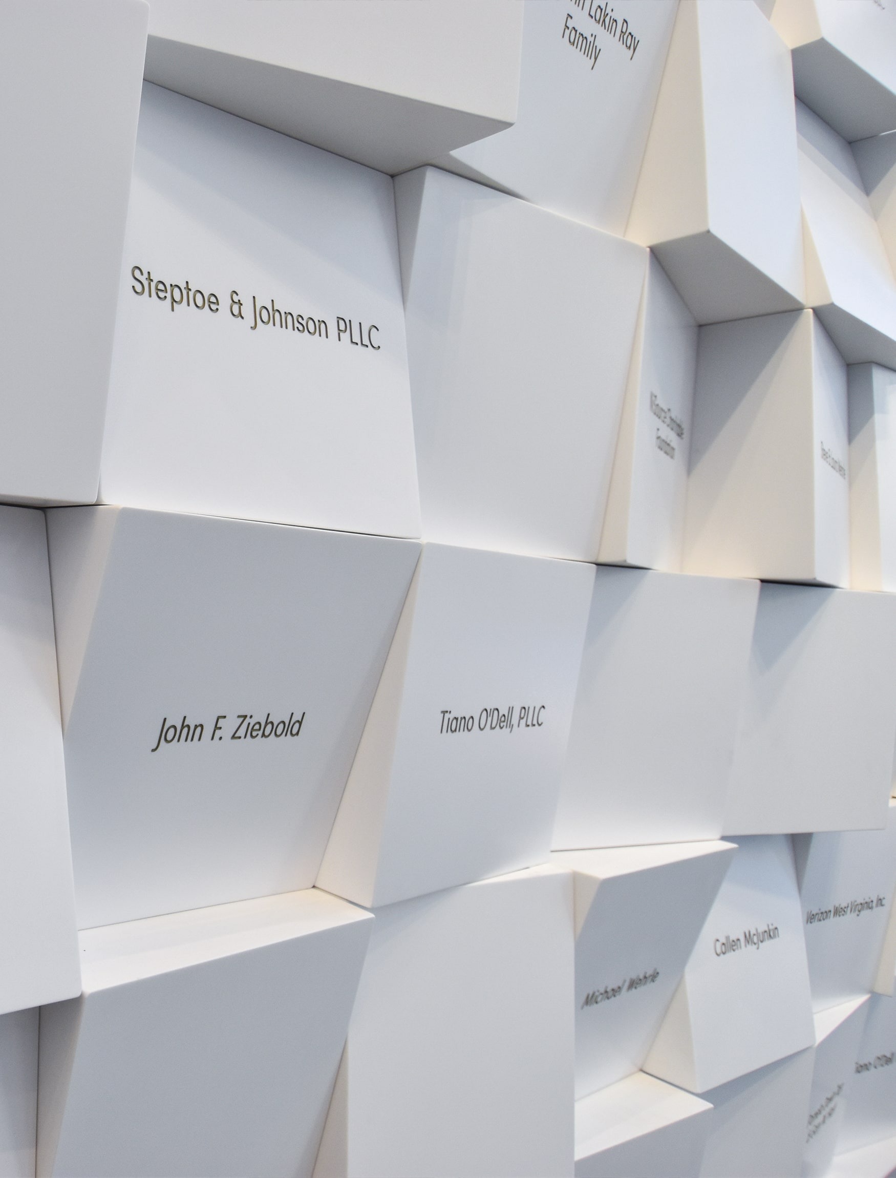 Detail shot of donor wall art by RSM Design. White blocks with gray engraved names for Kanawha County Public Library.