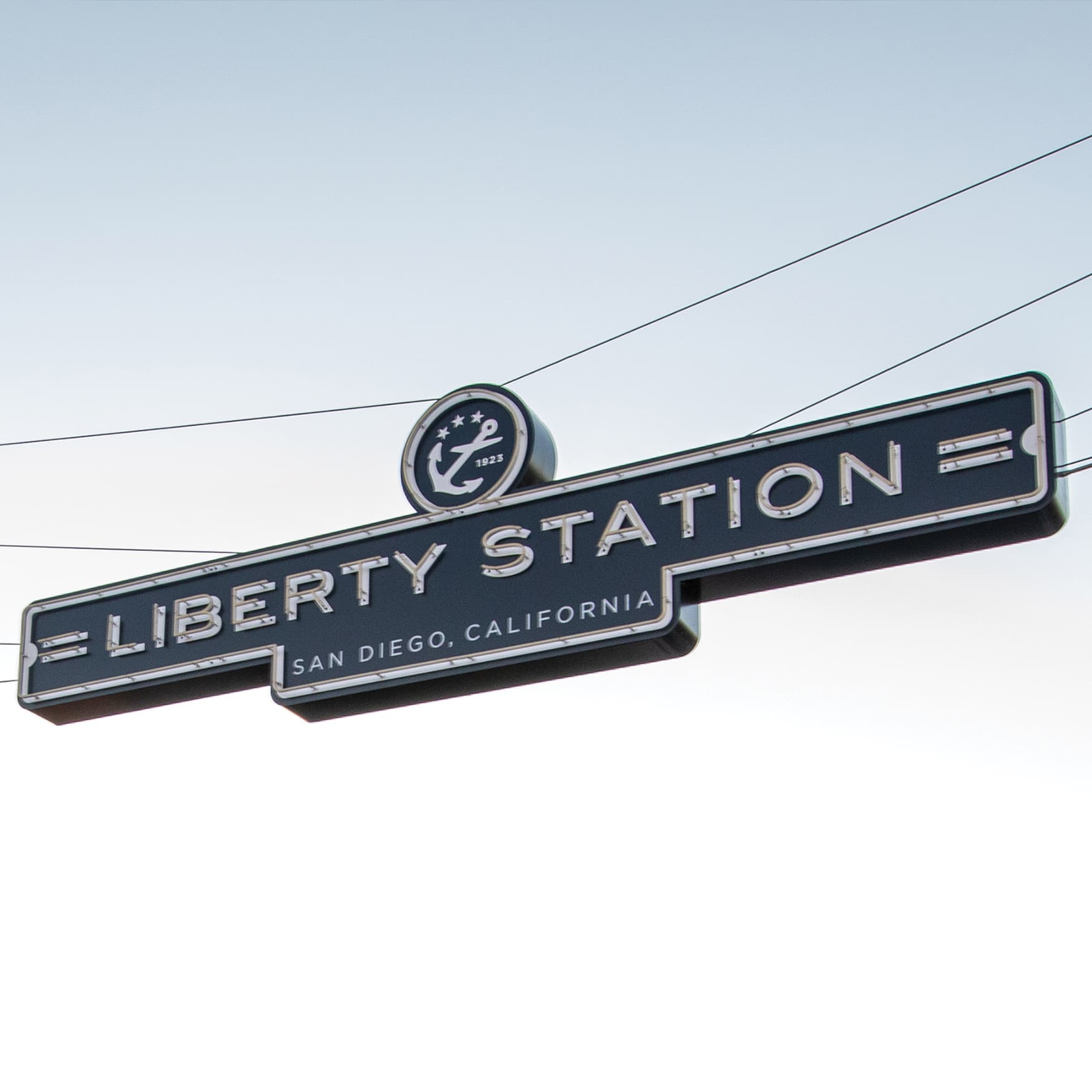 Liberty Station entrance neon signage suspended across the street