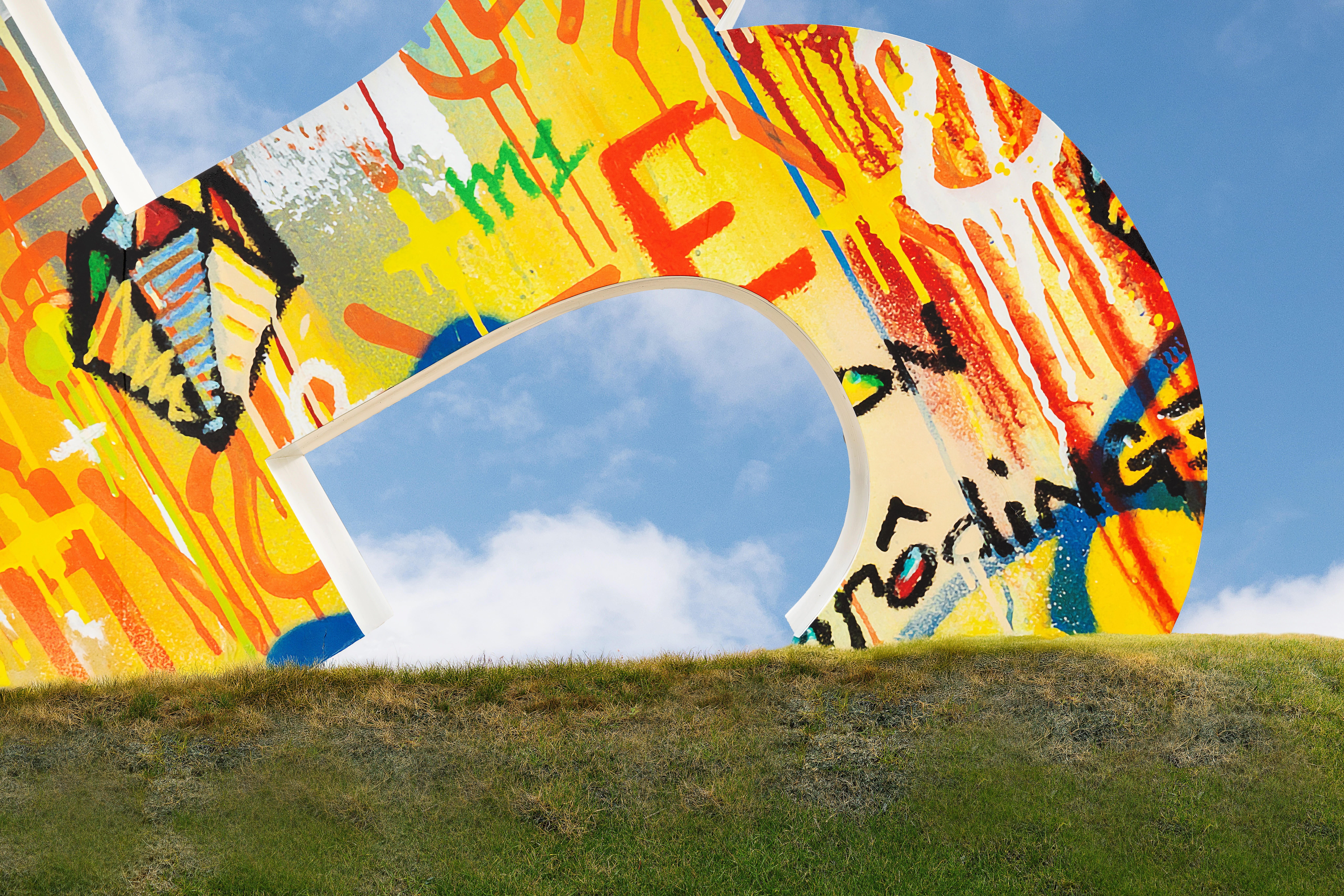 Large-scale public art installation integrated into the landscape, featuring colorful environmental graphics and sculptural form that support placemaking, experiential design, and brand storytelling within a mixed-use retail and community destination by RSM Design