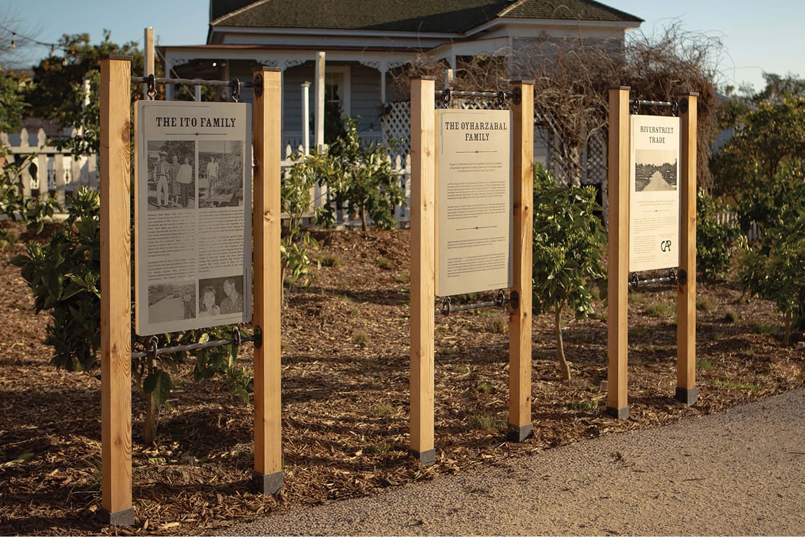 River Street Marketplace historic family interpretive signage along garden path, environmental graphic design by RSM Design