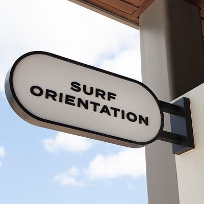 Surf Orientation oval blade sign against blue sky at Wai Kai, Ewa Beach, Oahu, wayfinding by RSM Design.