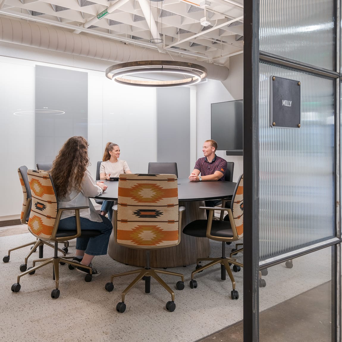 The Armour Stockyards conference room named Molly with patterned chairs, environmental graphic design by RSM Design