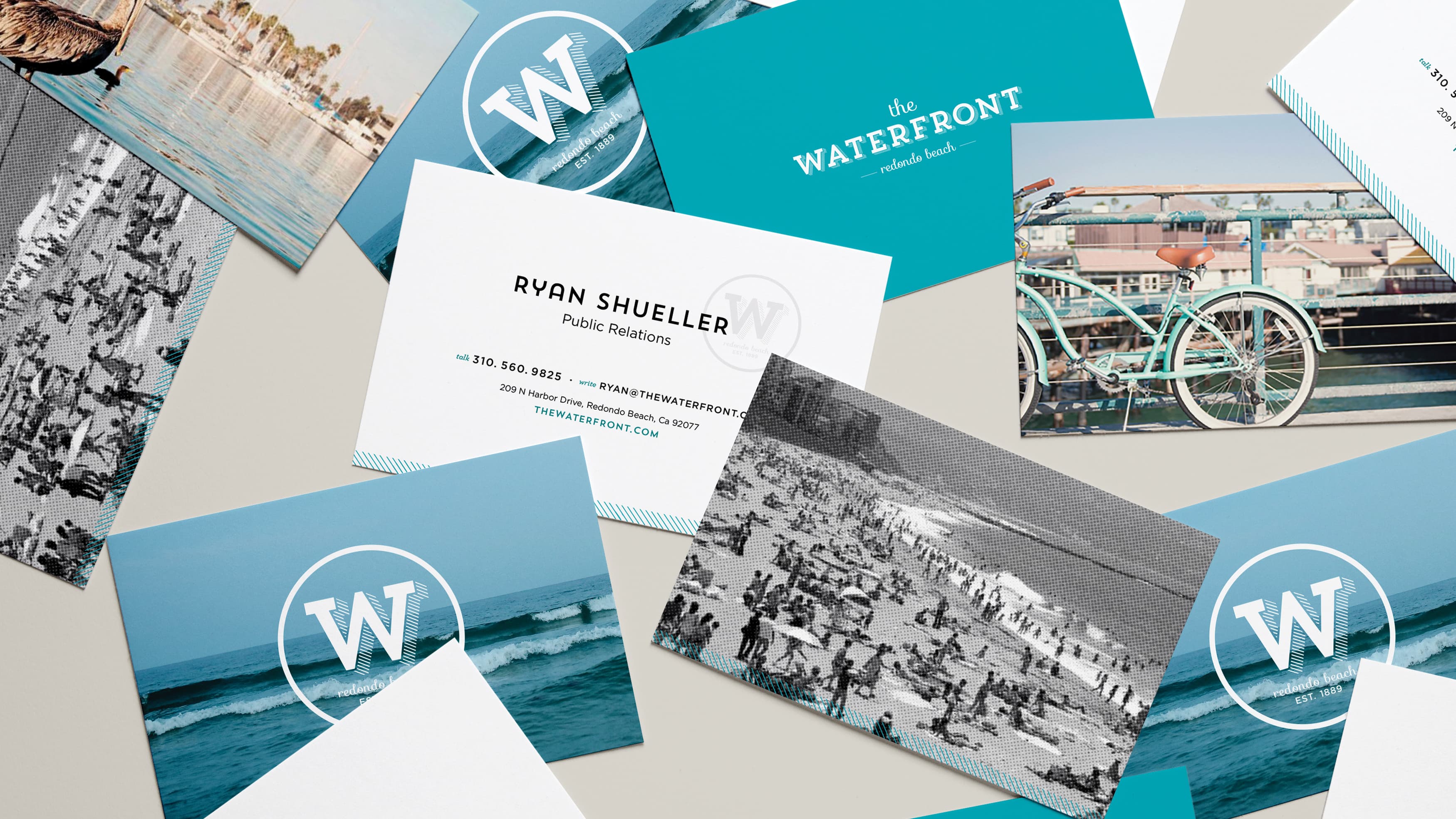 Logo design for CenterCal Properties' The Waterfront on postcards on a table.