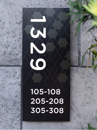 Persea residential community building address and unit range signage with geometric pattern, wayfinding design by RSM Design
