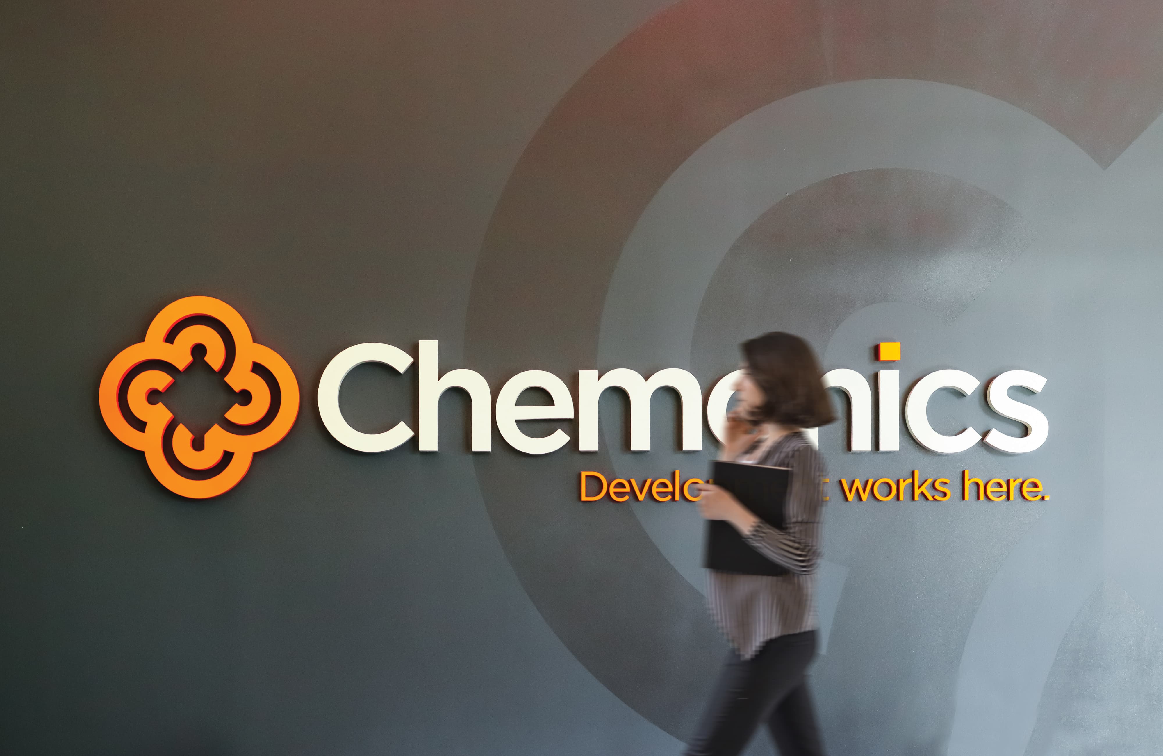 Branded interior wall graphics and dimensional logo signage for a corporate workplace, illustrating environmental graphic design, brand identity, and experiential graphics that enhance user experience in commercial office environments.