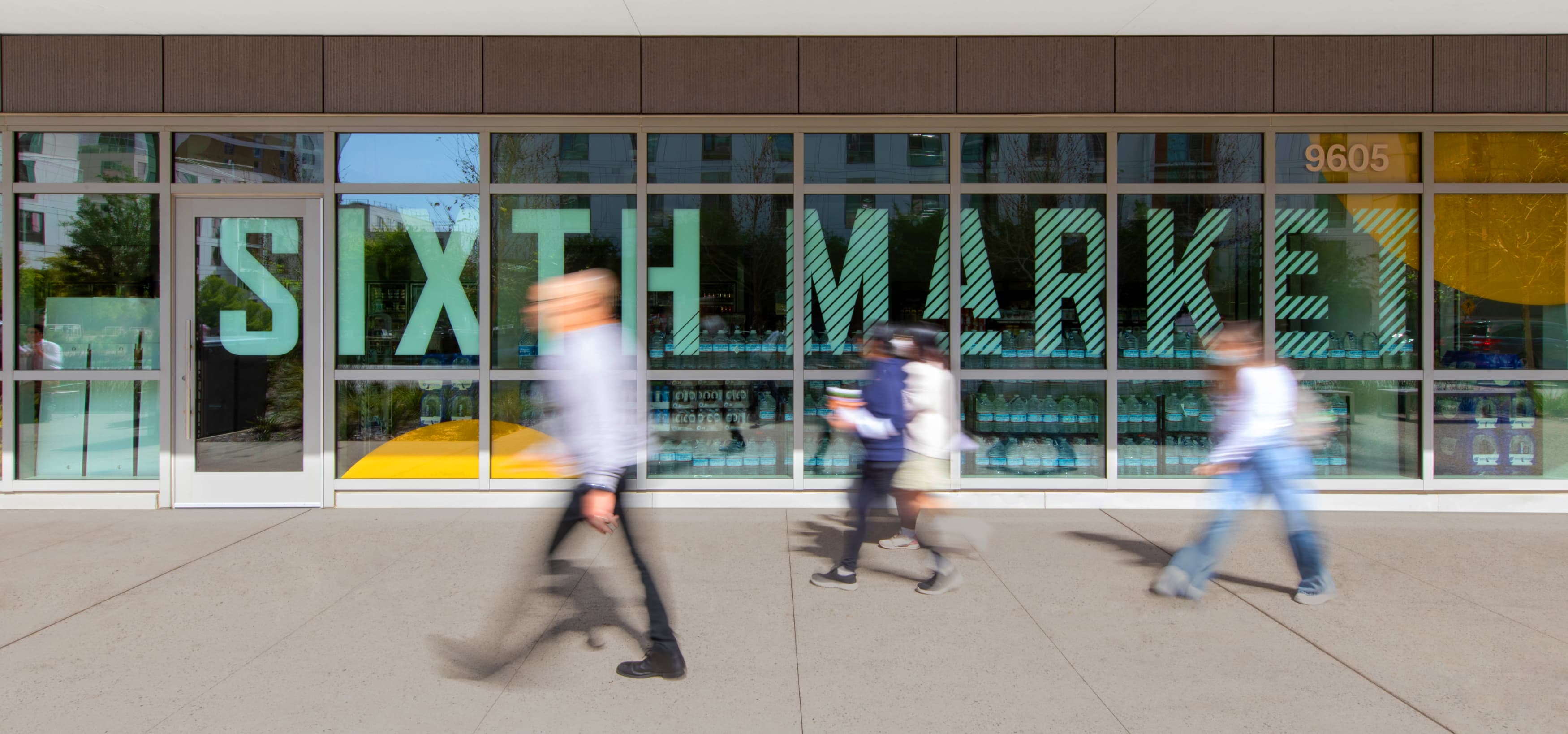 White "Sixth Market" vinyl identity graphic on window for UC San Diego Sixth Market dining hall by RSM Design in San Diego, California.