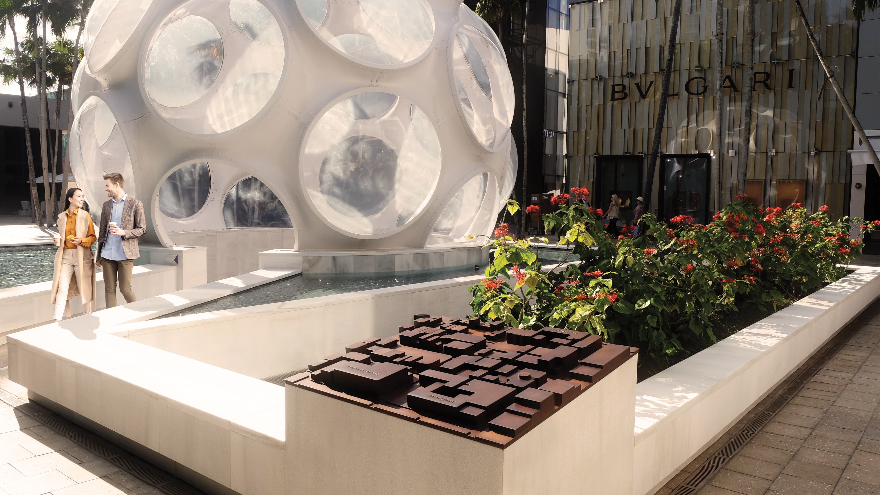 Three-dimensional site map placed by water feature and sculptural-art installment