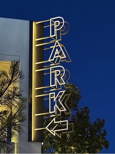 Dana Point Harbor illuminated vertical park sign with outlined letterforms at dusk — environmental graphic design by RSM Design