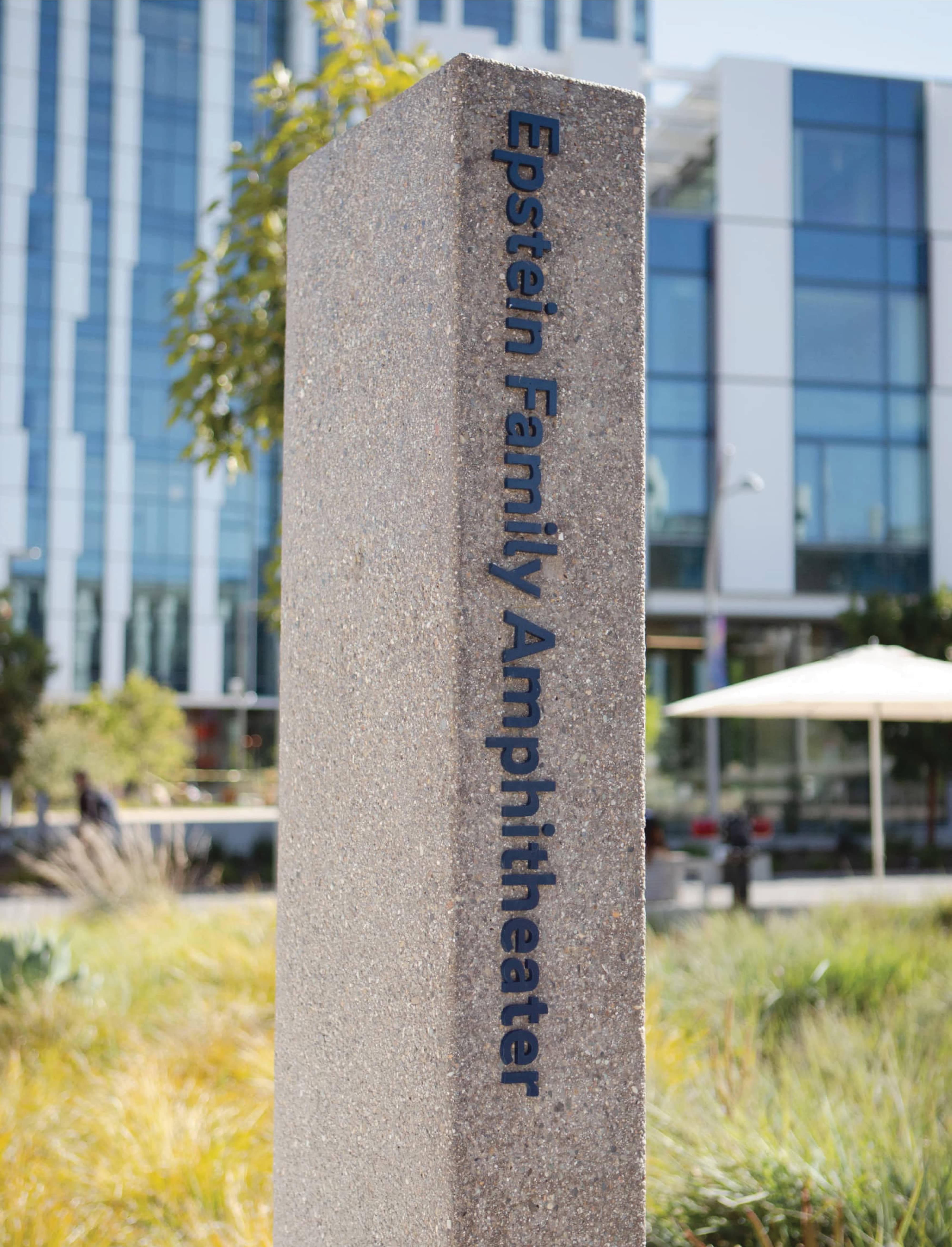 Epstein Family Amphitheater wayfinding marker in cast concrete, demonstrating environmental graphic design, signage systems, and placemaking within a mixed-use campus and outdoor public space by RSM Design
