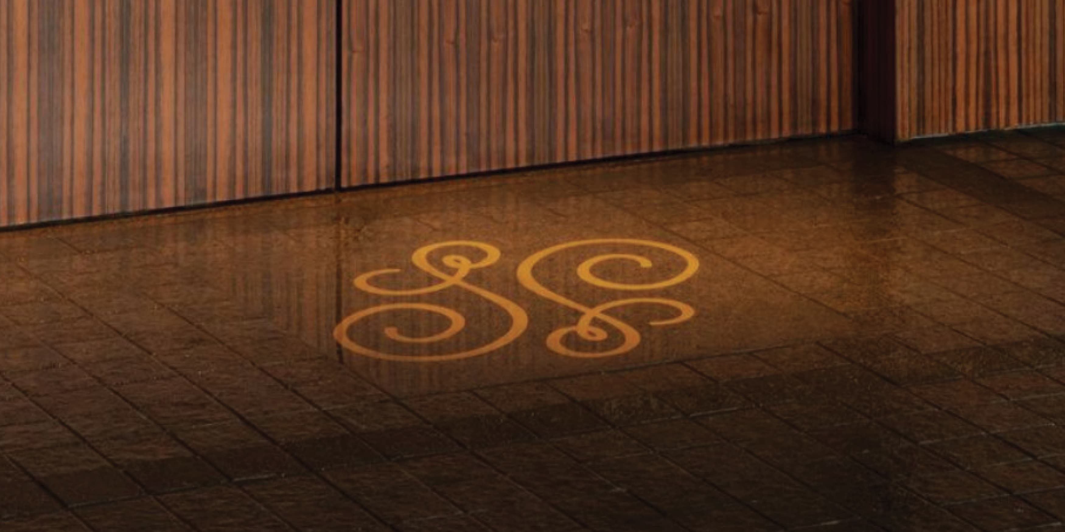 Image of the logo graphic for the Hotel Swexan on the floor of the entrance of the Dallas hotel, designed by RSM Design. 