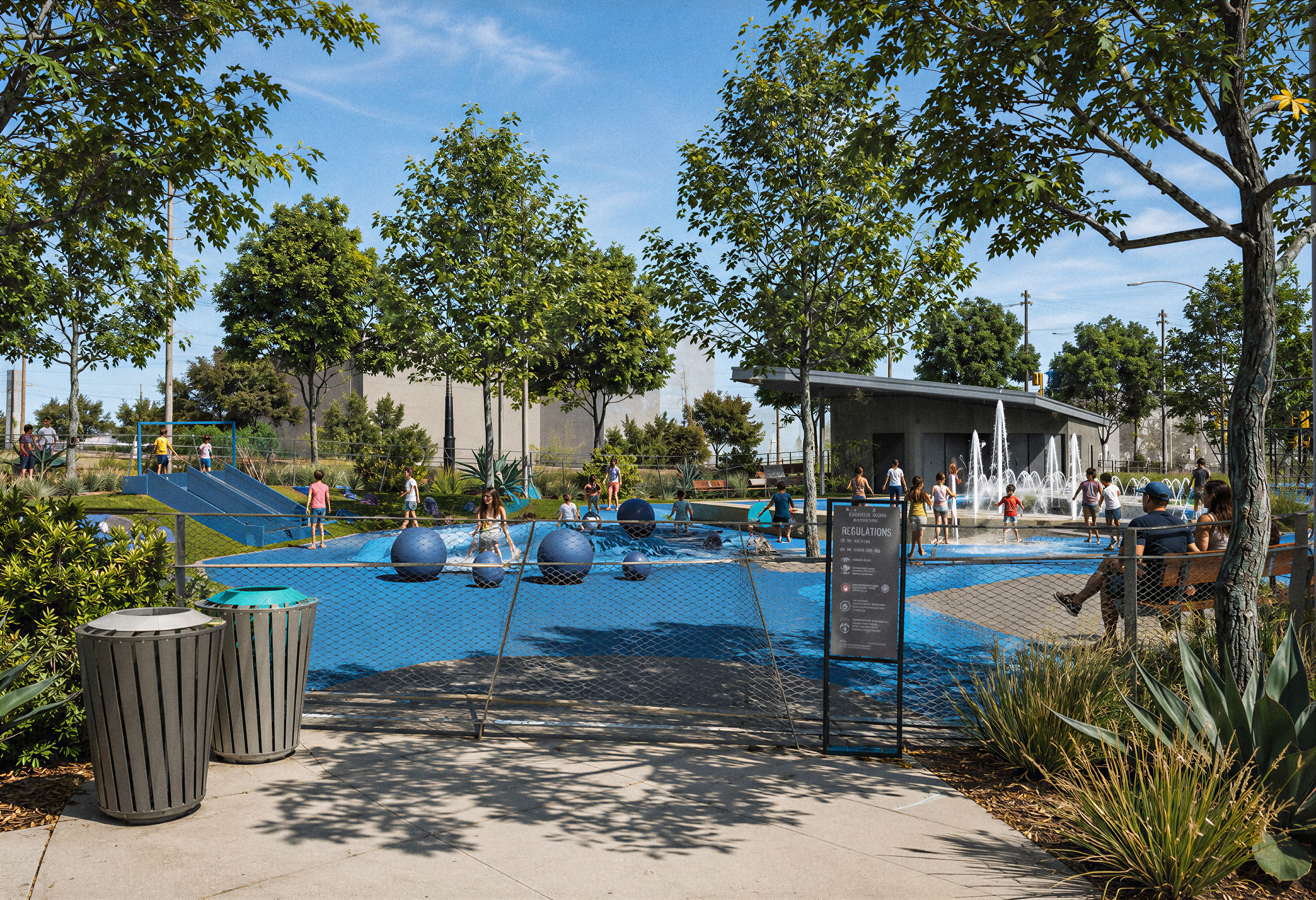 Splash pad play area at East Village Green with children playing among spherical fountain jets and a bridge slide, a 'Regulations' sign posted at the entrance gate, and a fountain plaza with families visible in the tree-shaded background.
