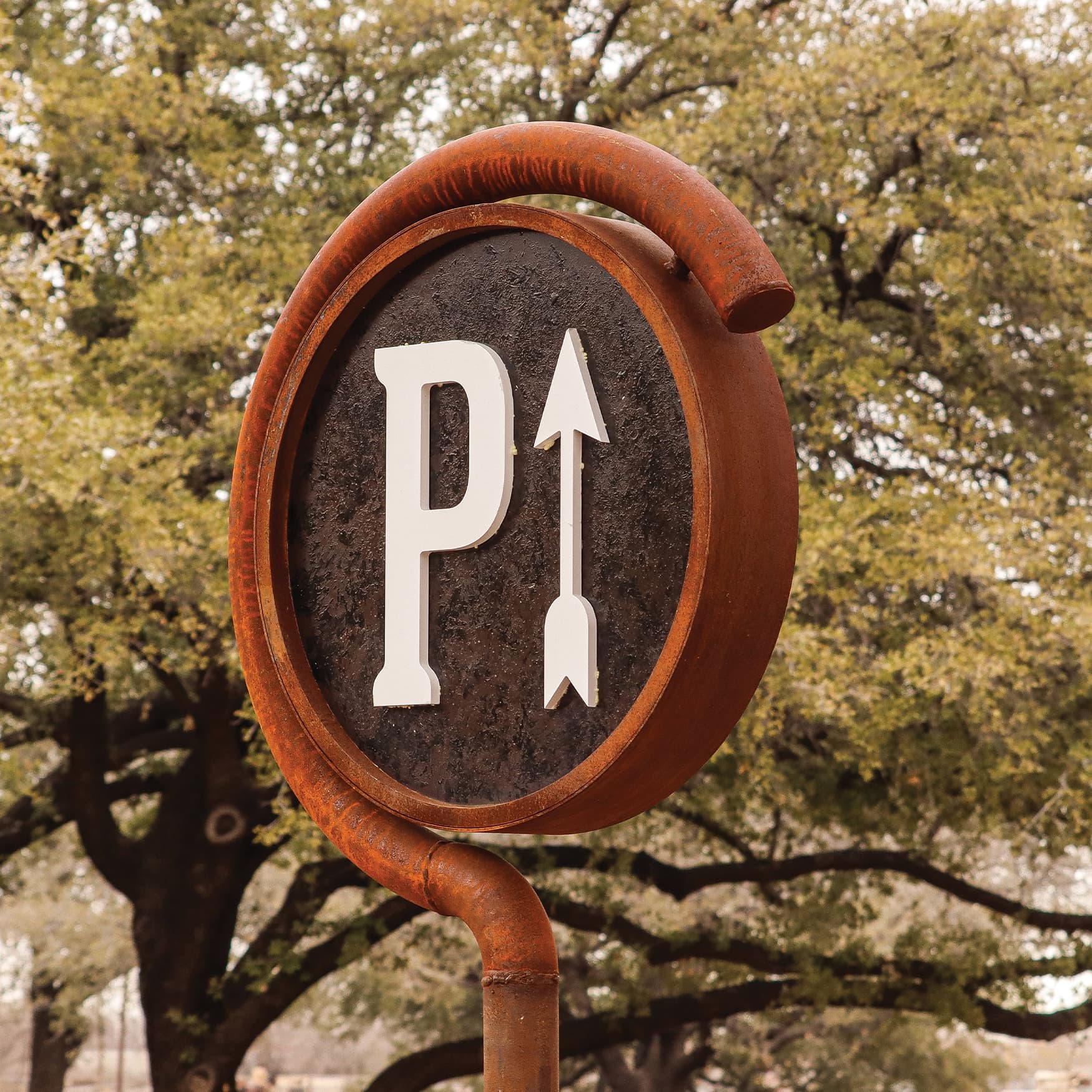 Close up detail image of a rustic style Parking directional sign.