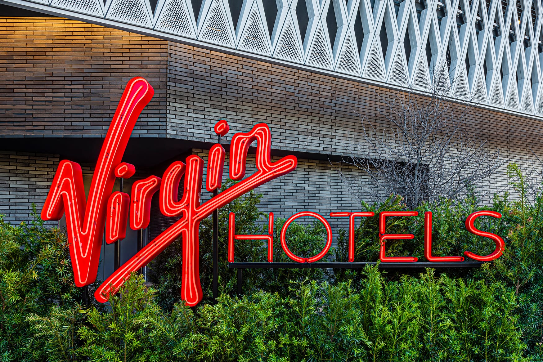 Virgin Hotels bold red neon exterior sign - architectural signage and environmental branding design services by RSM Design, a leading sign and wayfinding design firm