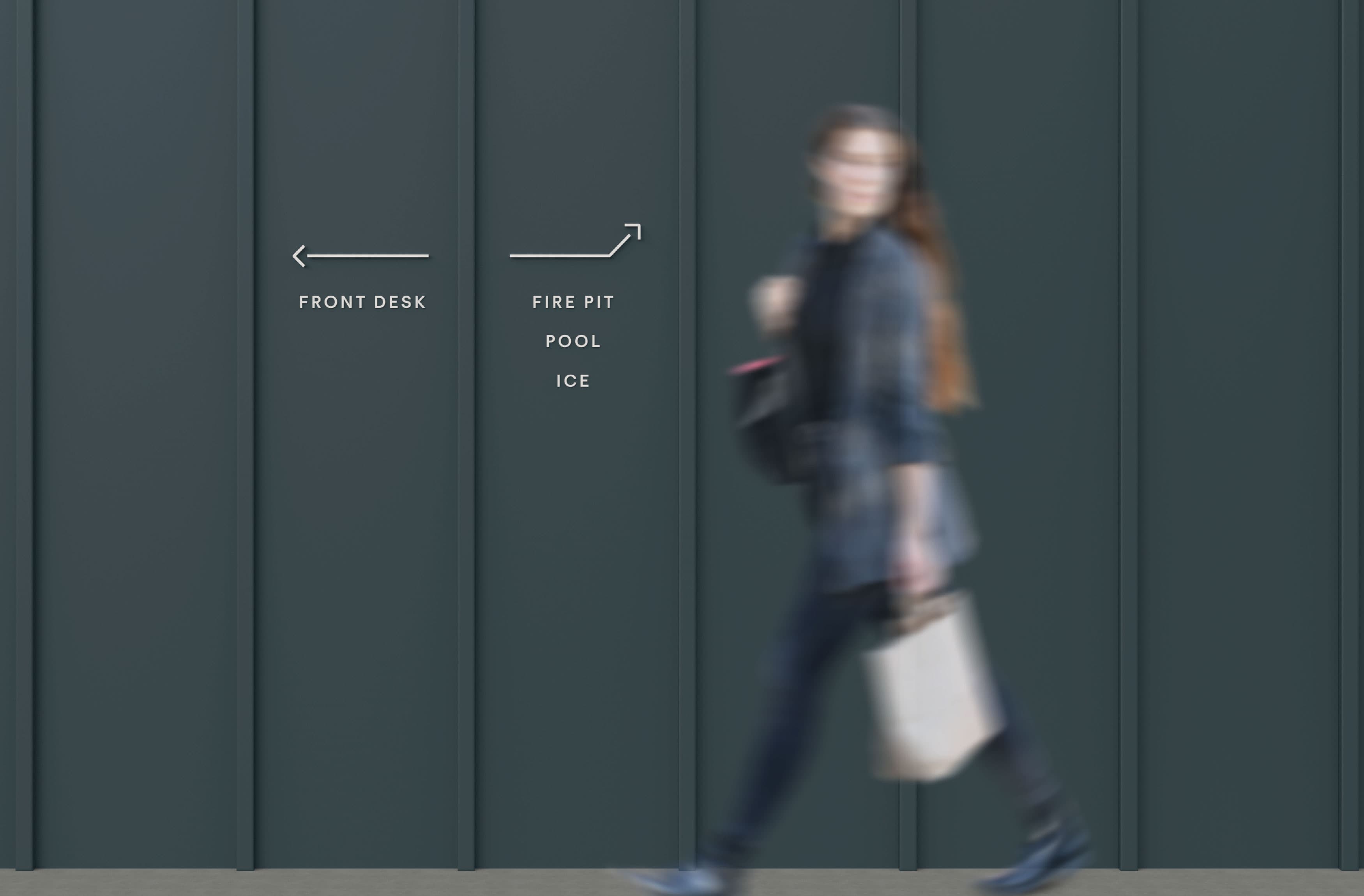 Women walking by the wayfinding wall directional at Trailborn Rocky Mountains. 