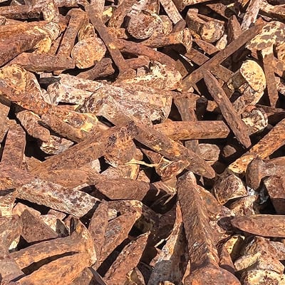 Close-up of weathered industrial metal fragments and rusted steel textures, reflecting the raw material history and industrial heritage of the Pearl Brewery site in San Antonio.