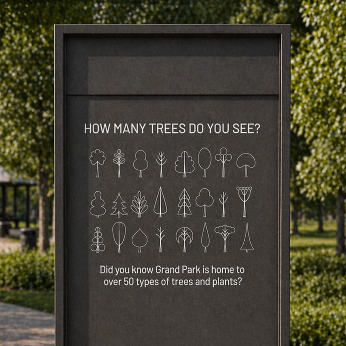 Dark interpretive sign at Grand Park displaying illustrated tree icons and the text "How Many Trees Do You See? Did you know Grand Park is home to over 50 types of trees and plants?"