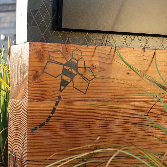 Persea residential community geometric bee icon detail on wood sign base, environmental graphic design by RSM Design
