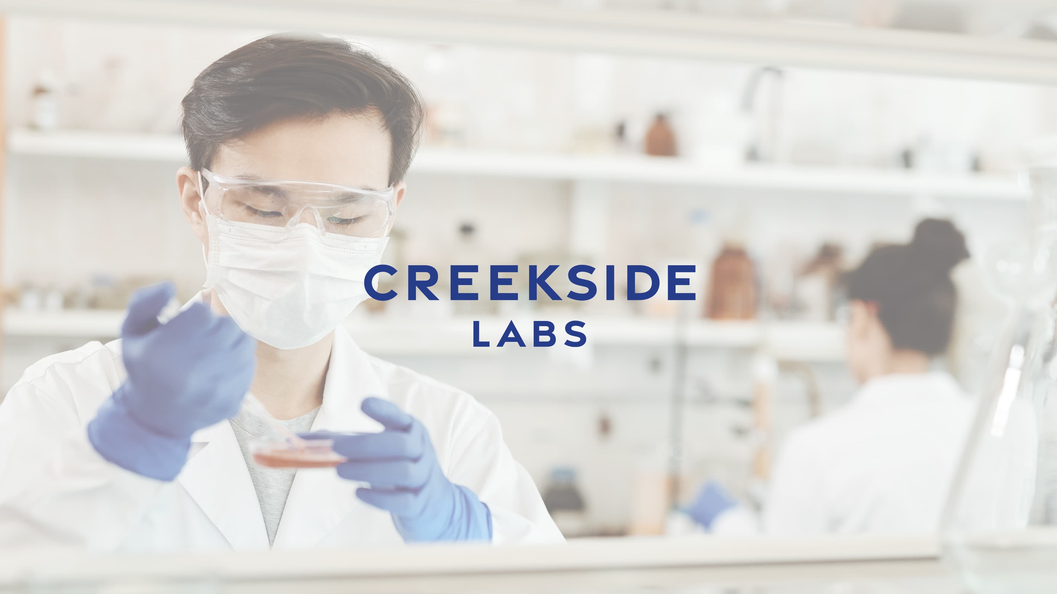 Creekside Labs logo against an image of a man with a syringe in a lab coat.