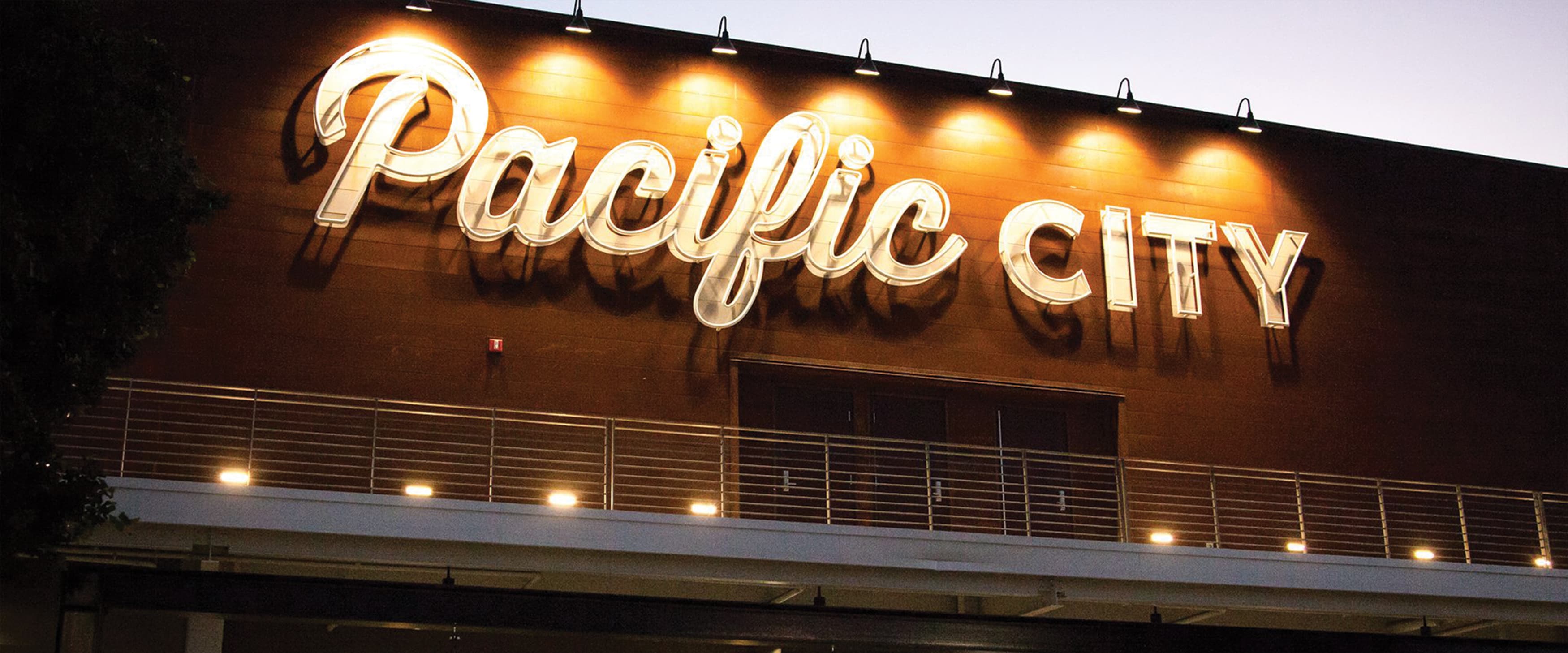 A large painted and exposed neon identity sign at Pacific City.