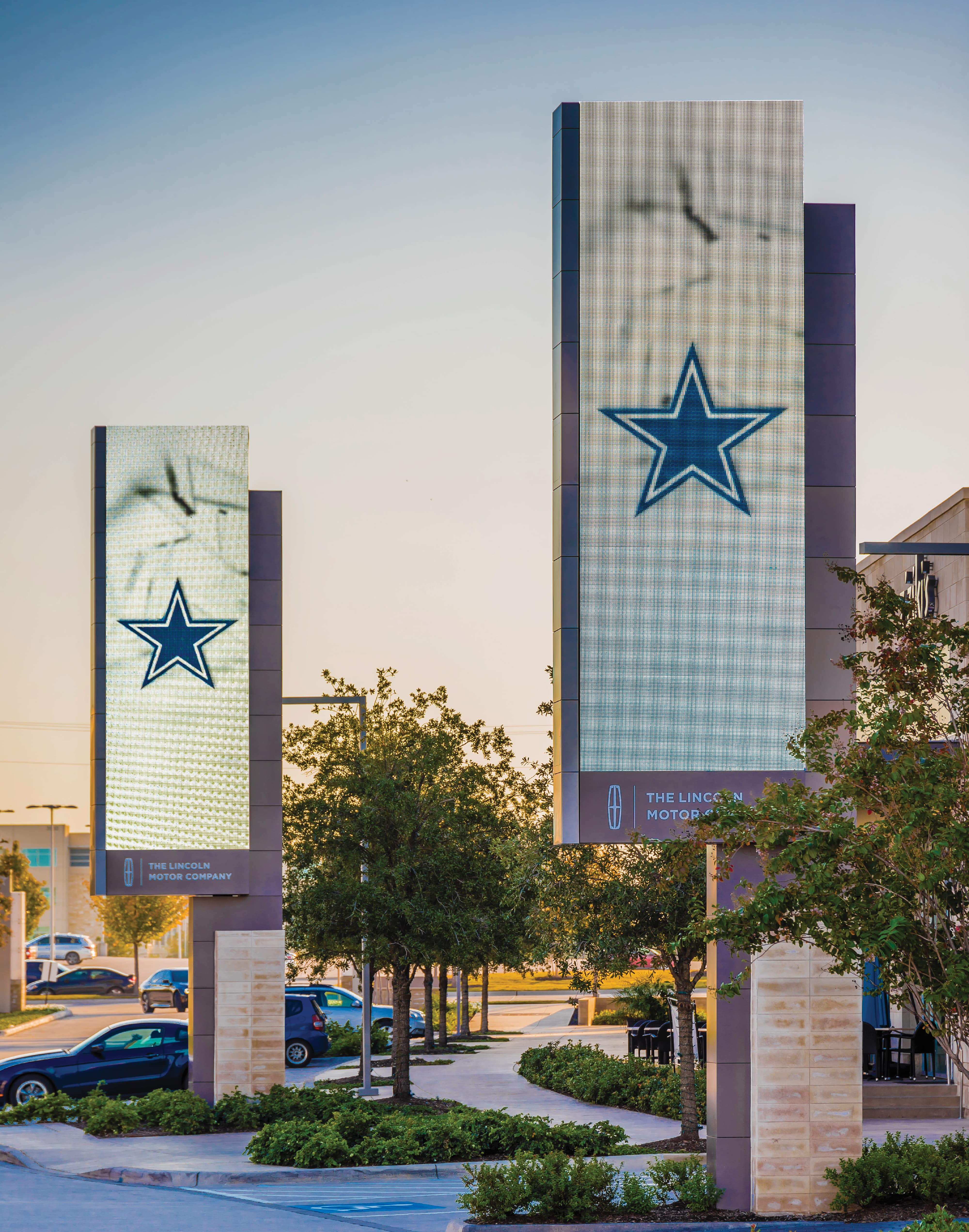 Large-scale exterior monument digital signage towers featuring the Dallas Cowboys star logo and The Lincoln Motor Company branding, designed by RSM Design as part of a master sign program for a sports and entertainment destination in the Dallas–Fort Worth area.