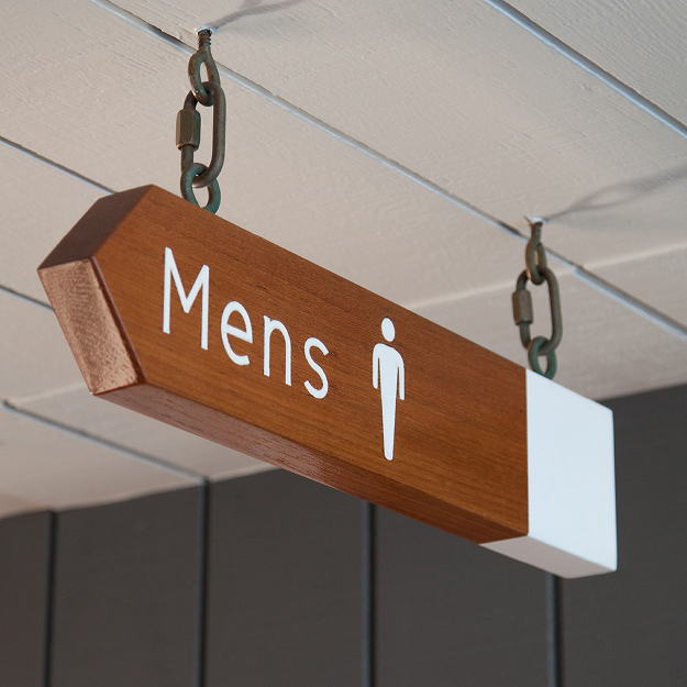 Lido Marina Village men's restroom hanging wood and white sign suspended by nautical chain links with white pictogram, Newport Beach, California