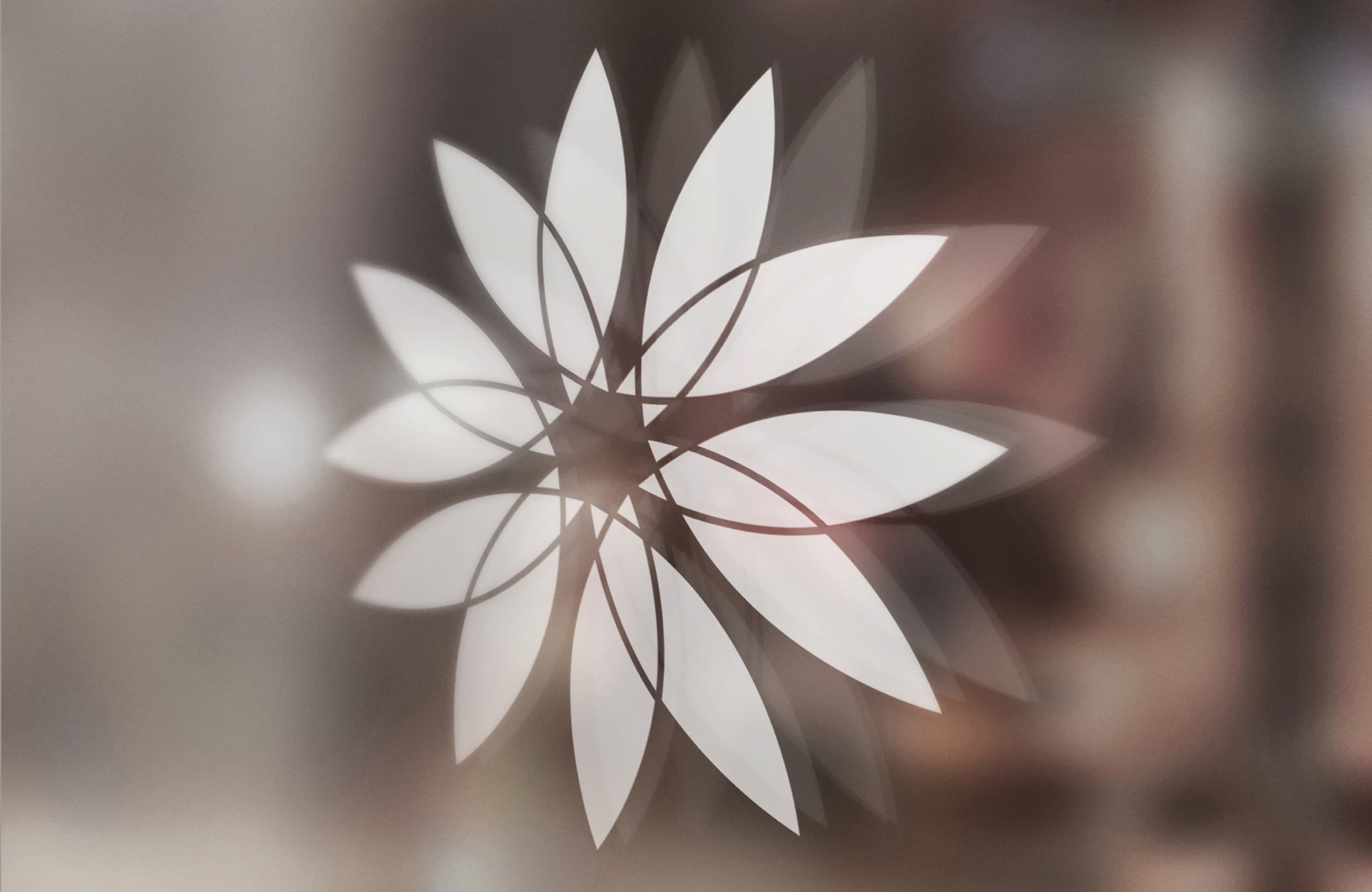 Close-up detail of Aerocity lotus flower brand mark applied as a frosted glass graphic on an interior surface at an international mixed-use destination — RSM Design branding and visual identity, specialty graphics, experiential graphics, and branded environments for mixed-use, retail, transit, and international destinations.