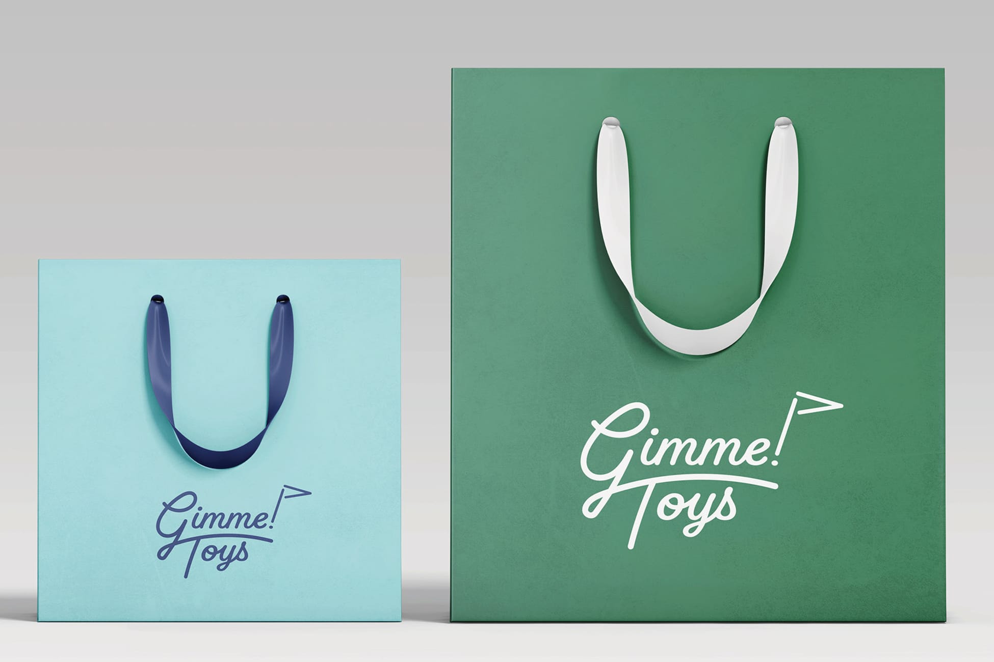 Gimme! Toys branded retail shopping bags in light blue and green featuring playful script logo with golf flag icon, children's gift shop packaging design at Omni PGA Frisco