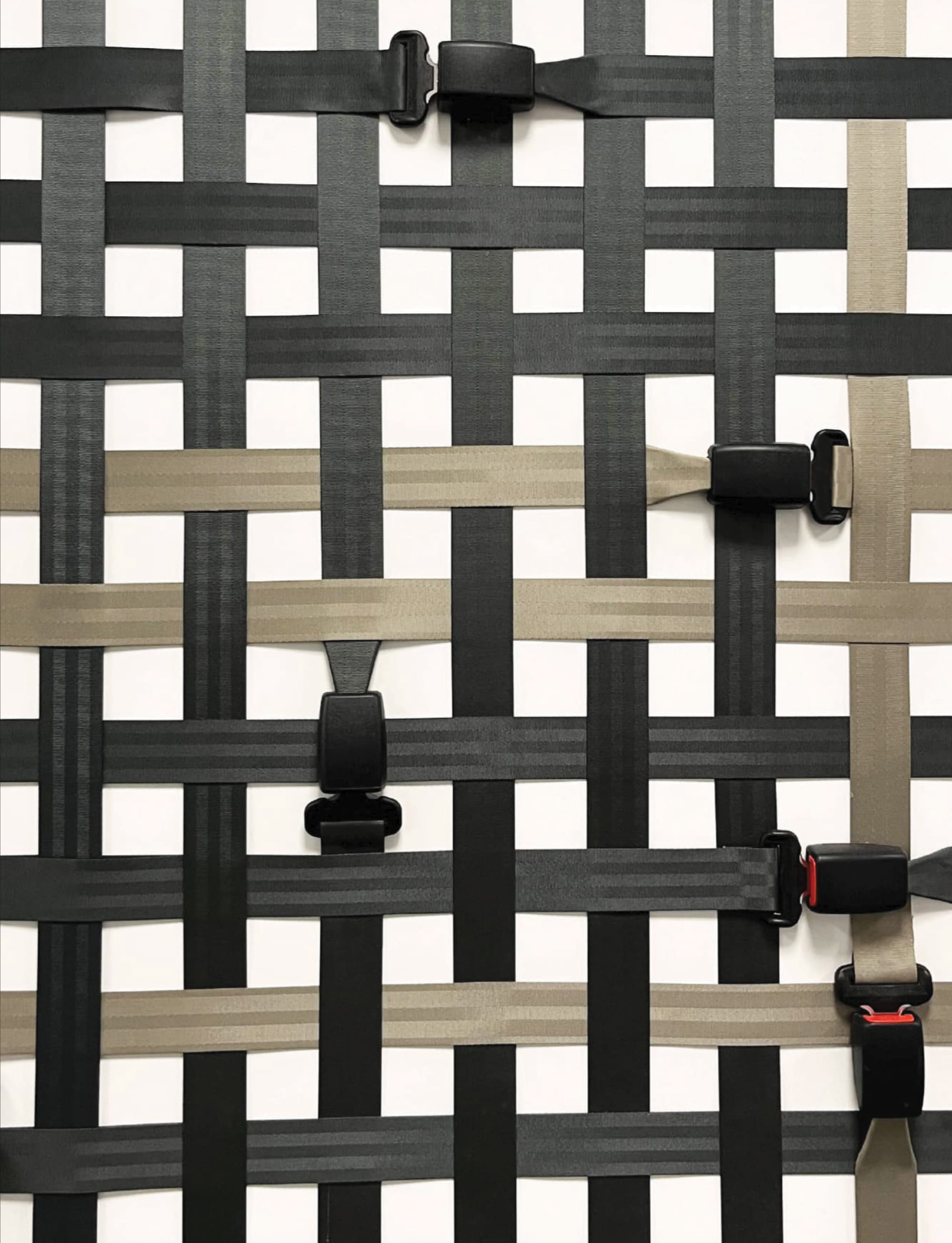 Close-up of branded material installation using woven straps and hardware, showcasing environmental graphic design detail, experiential design craftsmanship, and brand integration for corporate workplace and innovation-focused environments.