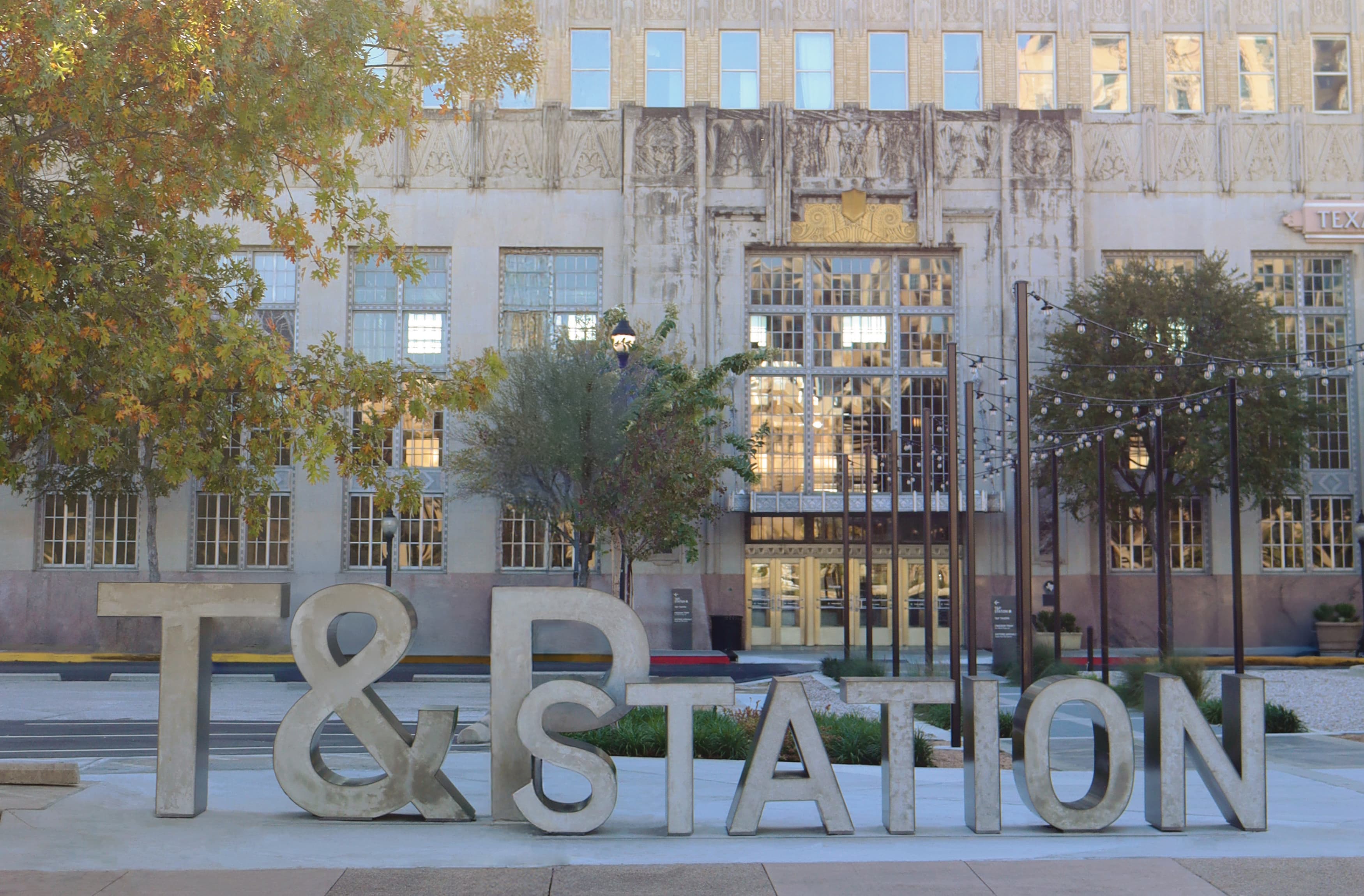 RSM Design's transformative work on the historic T&P Train Station showcases their expertise in environmental graphic design. The project revitalizes the station with impactful wayfinding signage and placemaking elements, blending modern aesthetics with the site's rich heritage. The large, bold "T&P STATION" letters in front of the building create a striking landmark, enhancing visibility and accessibility. This innovative approach not only guides visitors but also enriches the cultural and historical significance of the space, reflecting RSM Design's commitment to creating meaningful connections between people and the built environment.