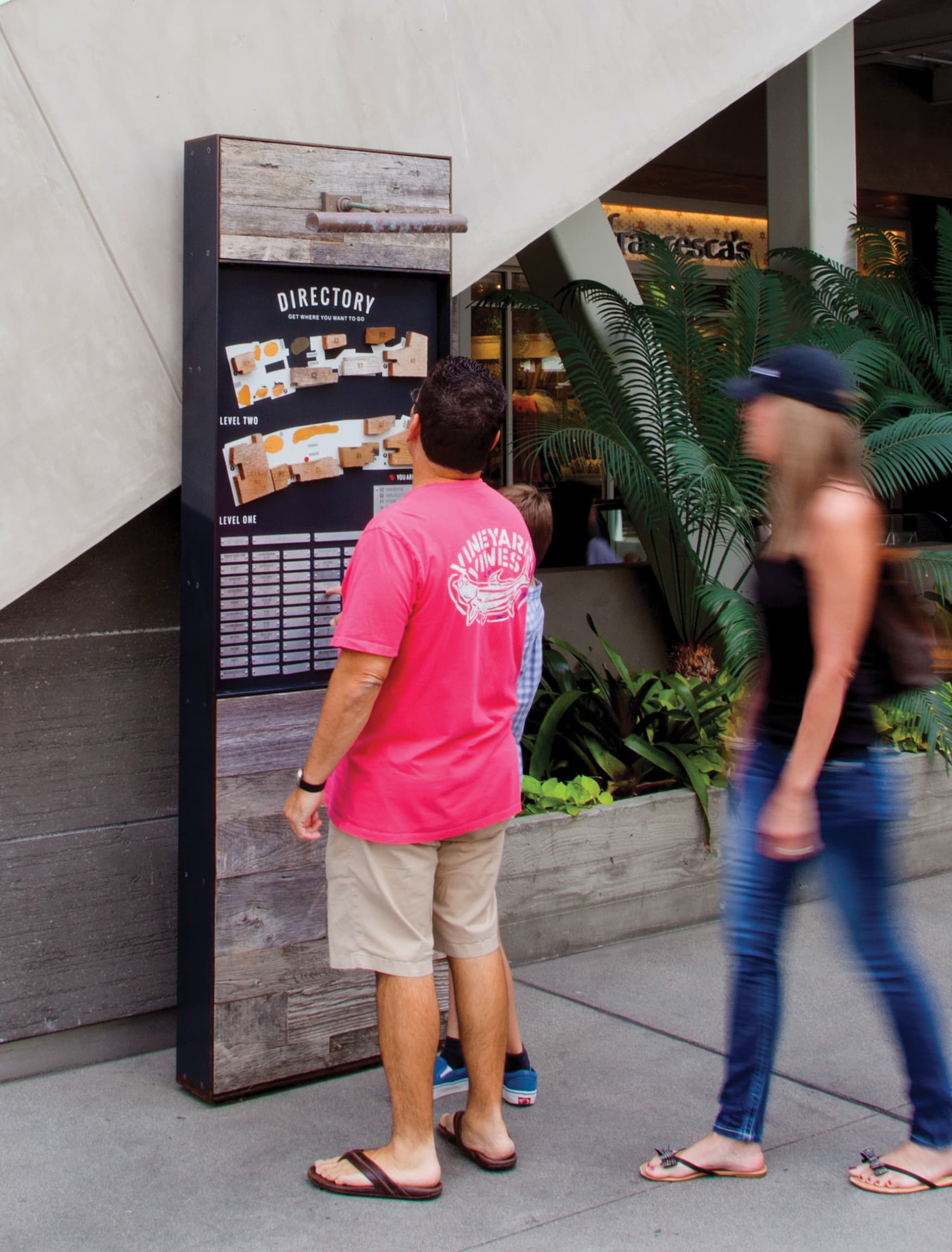 Image of two people looking at the directory at Pacific City, designed by RSM Design. 