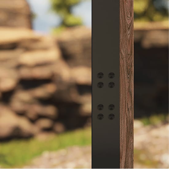 Detail of Tenaya at Yosemite signage post, showing matte black steel column with bolt detail and wood veneer accent against a rocky landscape