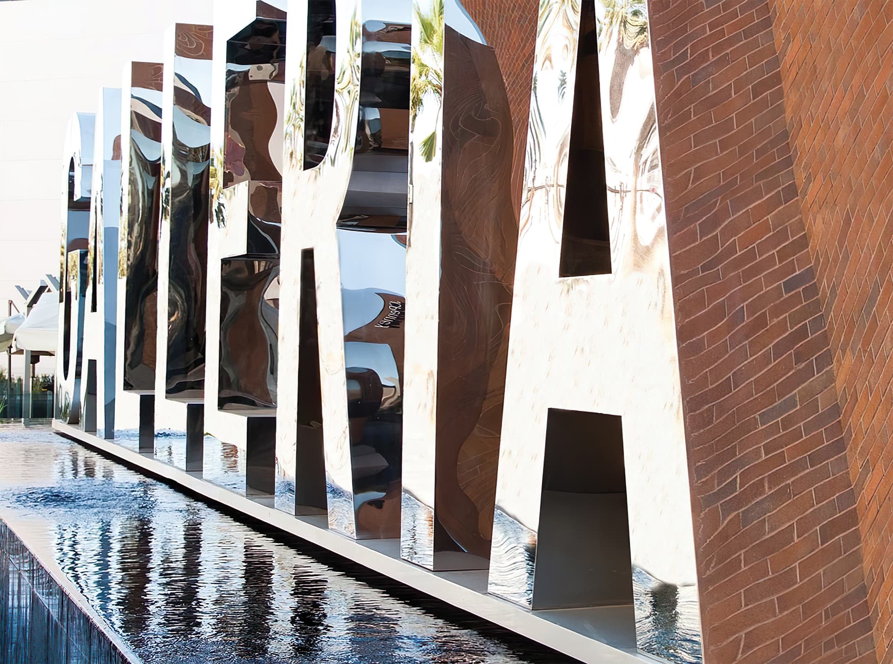 Glendale Galleria. A retail destination in Glendale, California. Sculptural Project Identity Monument with reflective chrome finish over a water feature.
