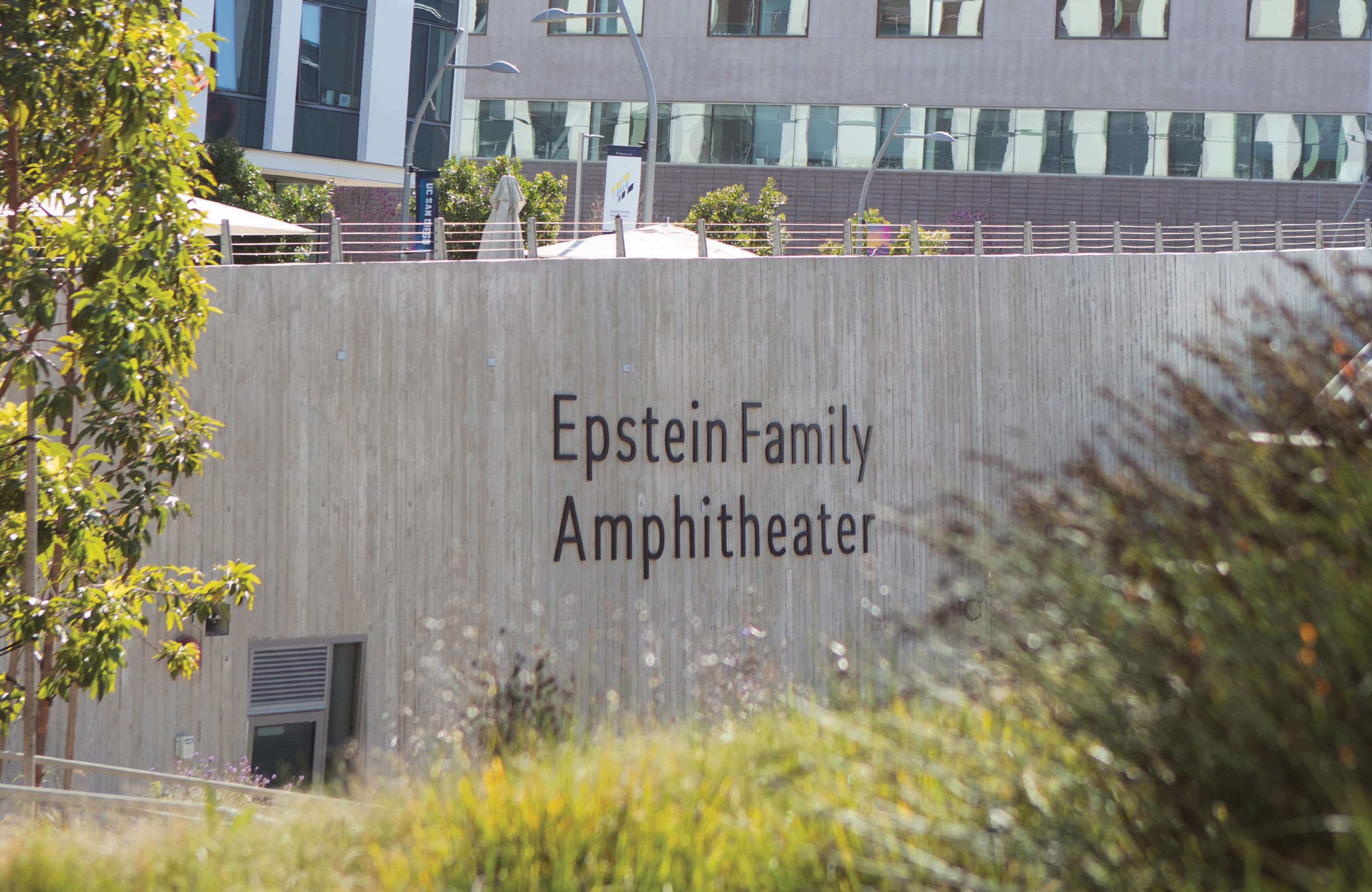 Epstein Family Amphitheater signage integrated into architectural concrete wall, illustrating environmental graphic design, wayfinding, and placemaking within a mixed-use campus and public gathering space by RSM Design
