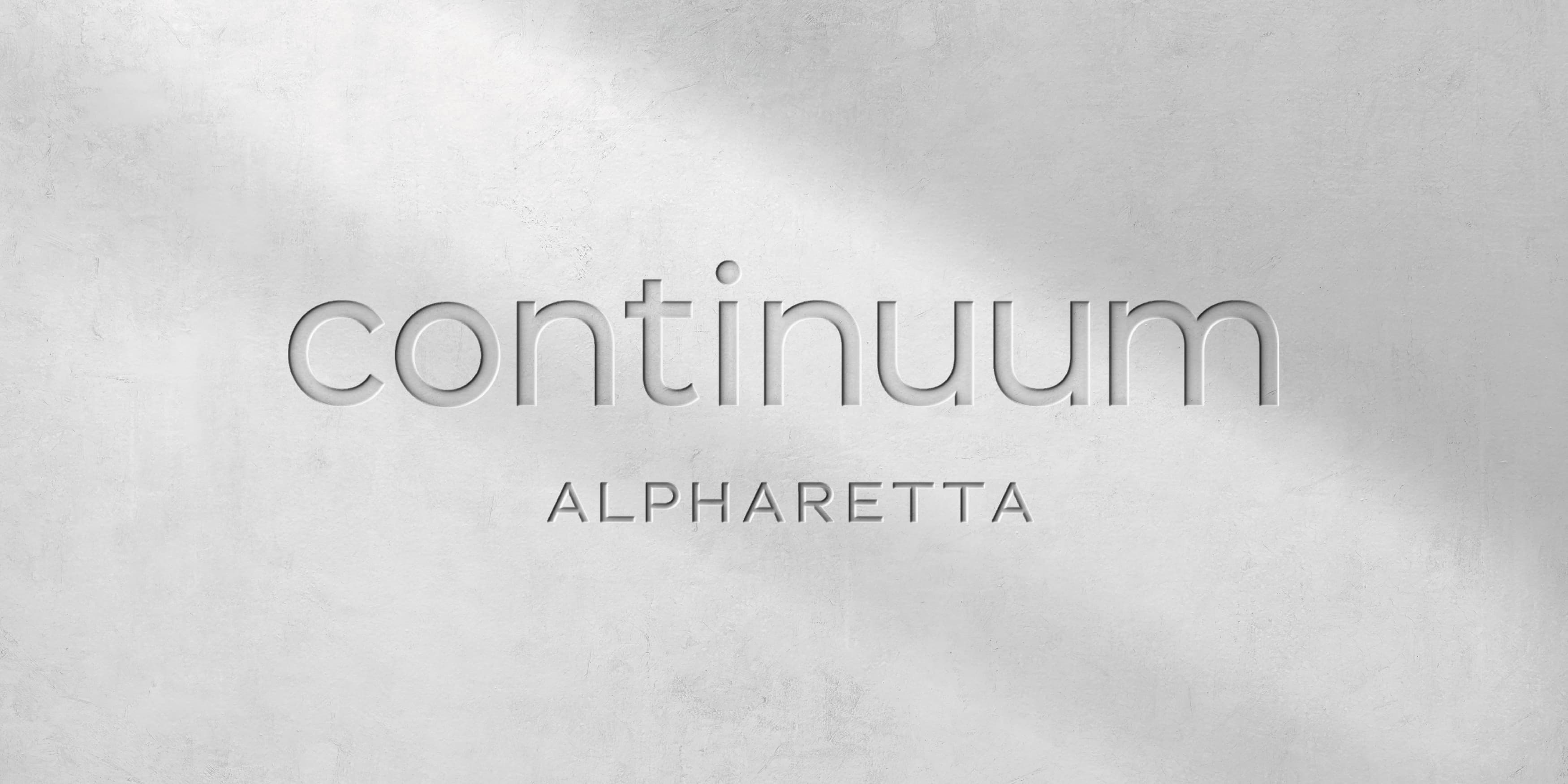 Image of the logo for Continuum Alpharetta on concrete, designed by RSM Design.