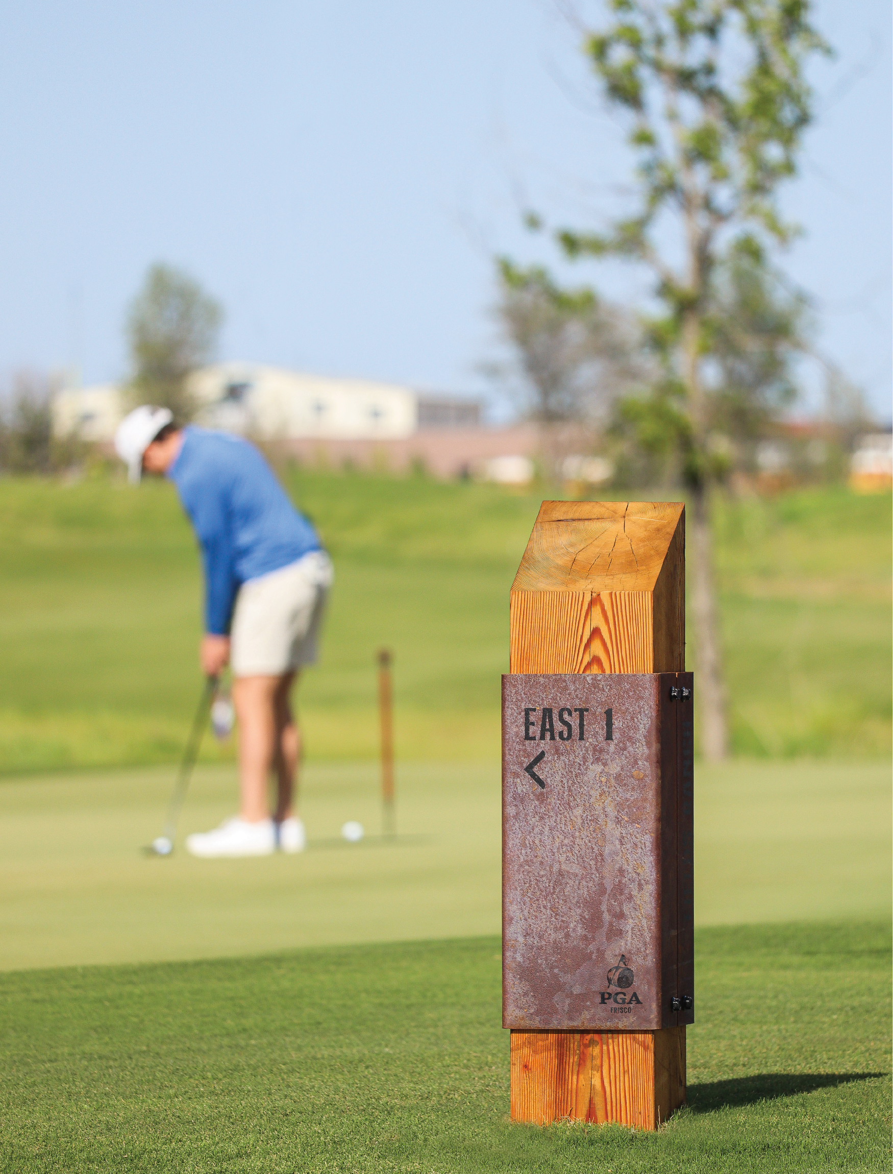 Golf course signage with golfer in the background. Signage designed by RSM Design. 