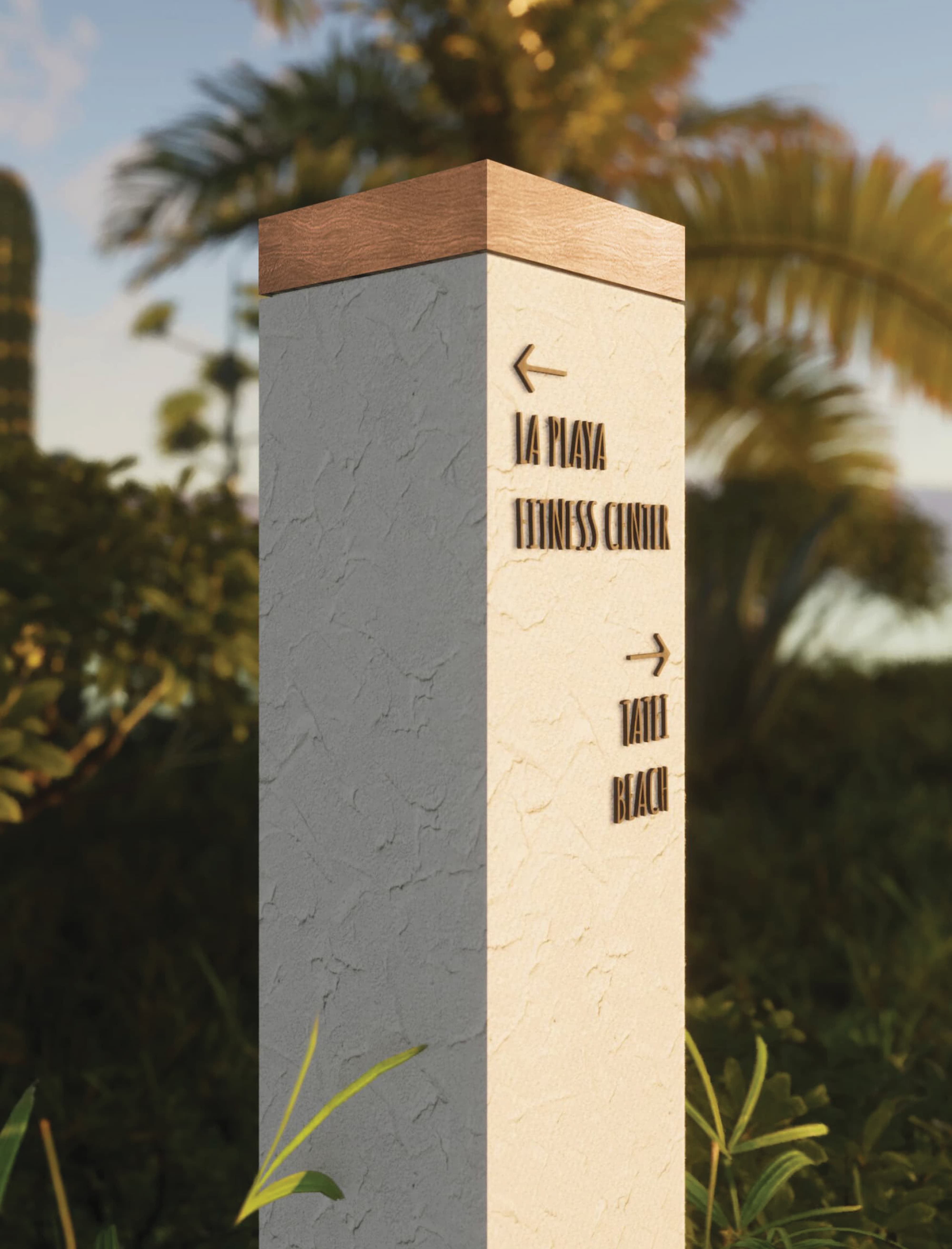 Monument wayfinding sign directing to La Playa Fitness Center and beach, integrated into coastal landscape, showcasing environmental graphic design, branded wayfinding systems, and placemaking for hospitality, residential, and resort destinations.