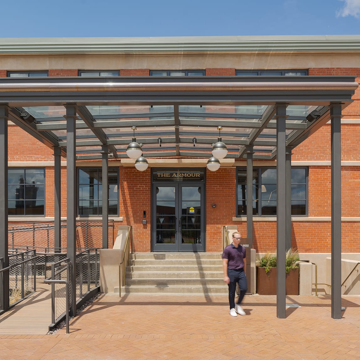 The Armour Stockyards front entrance canopy with brick facade signage, environmental graphic design by RSM Design