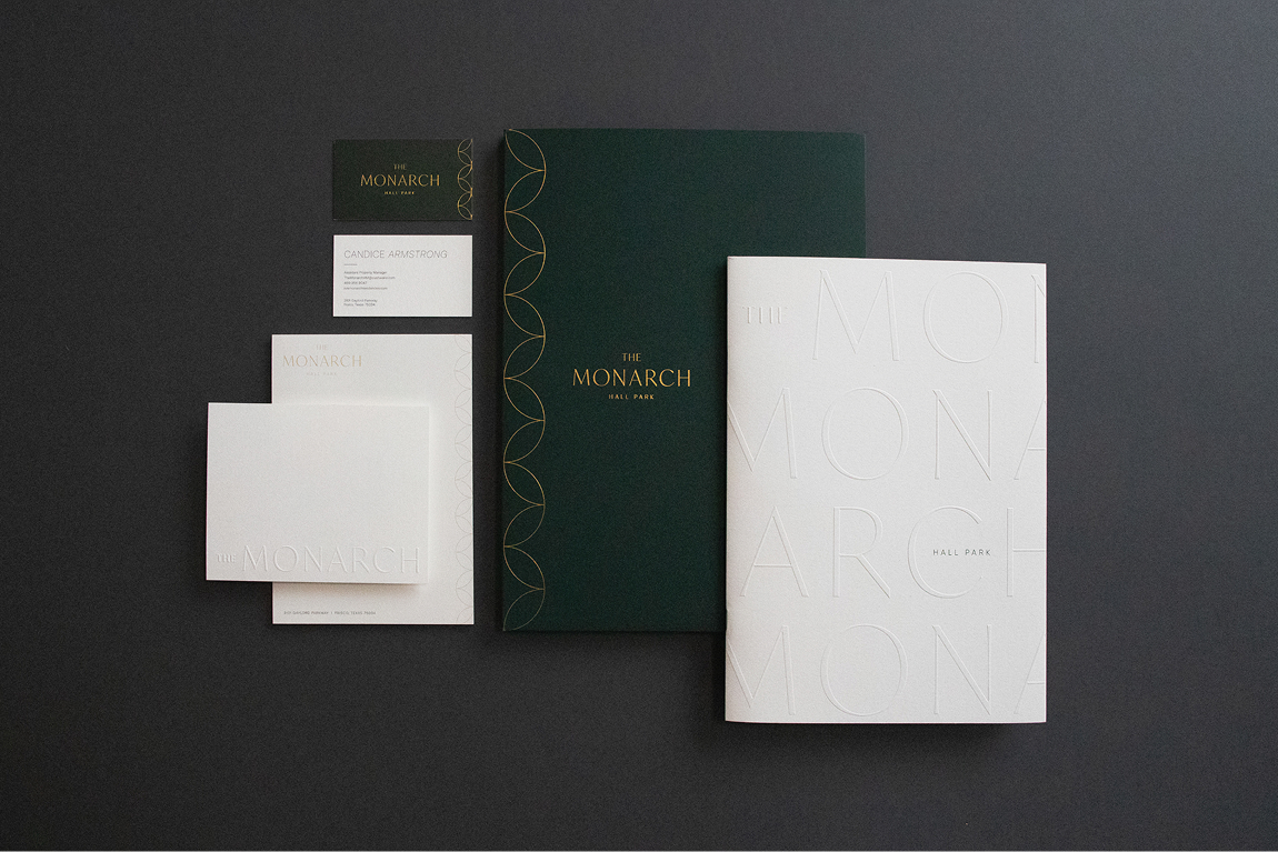 The Monarch at Hall Park luxury residential brand stationery suite — business cards, notecards, envelopes, folder, and embossed brochure with gold foil detailing, brand identity and print collateral by RSM Design