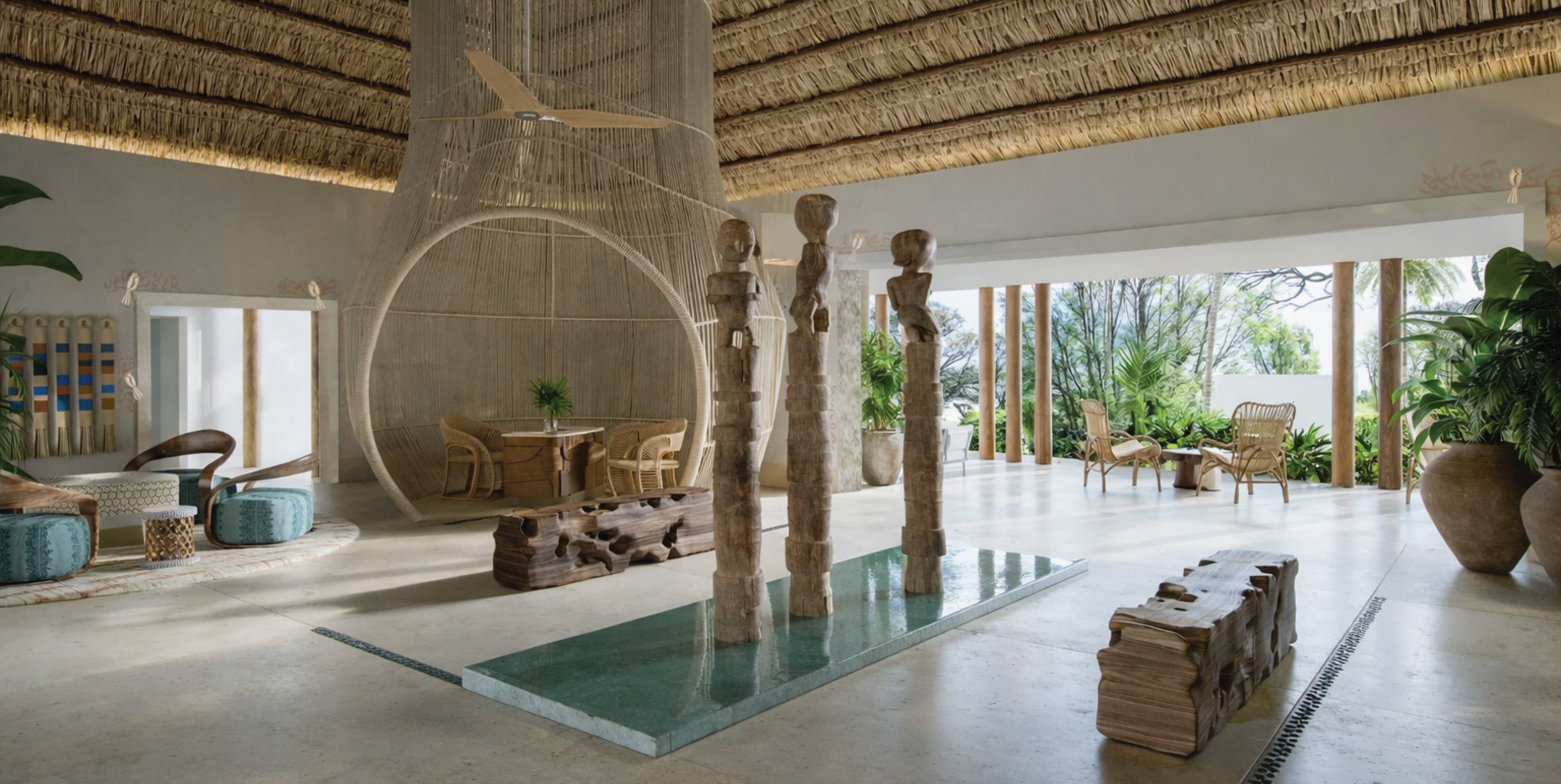 Open-air resort lobby with curated art, natural materials, and indoor-outdoor seating, showcasing experiential placemaking, environmental graphic design, and brand-driven hospitality environments for luxury resorts and mixed-use destinations.