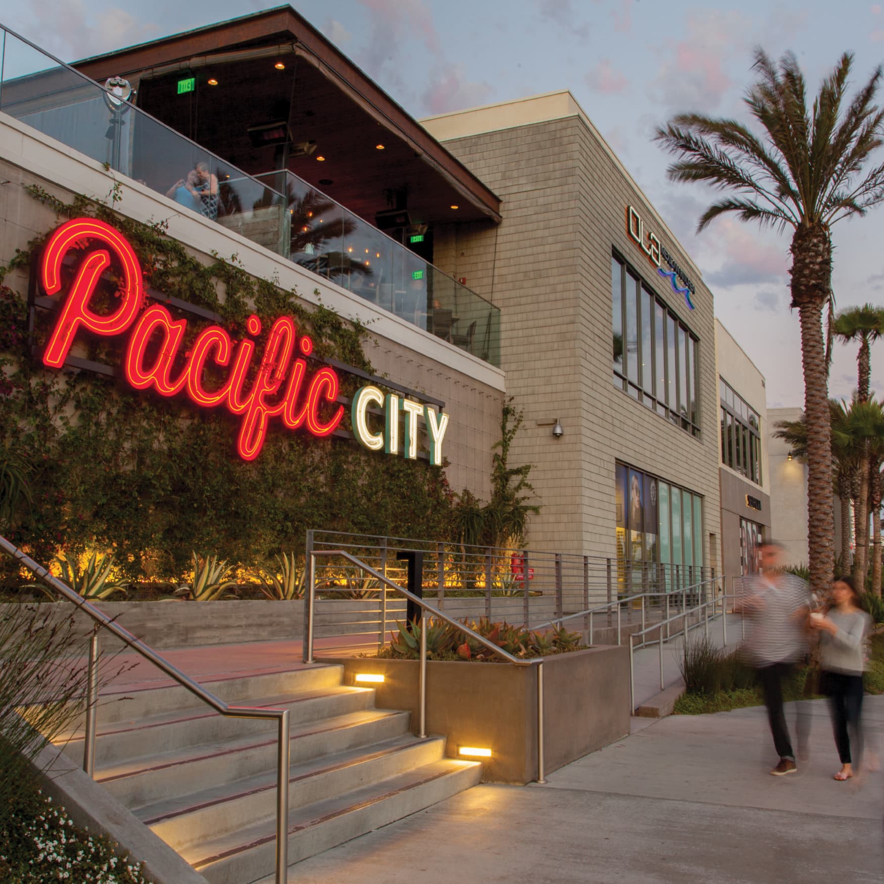 People walking past Pacific City in Huntington Beach, CA.