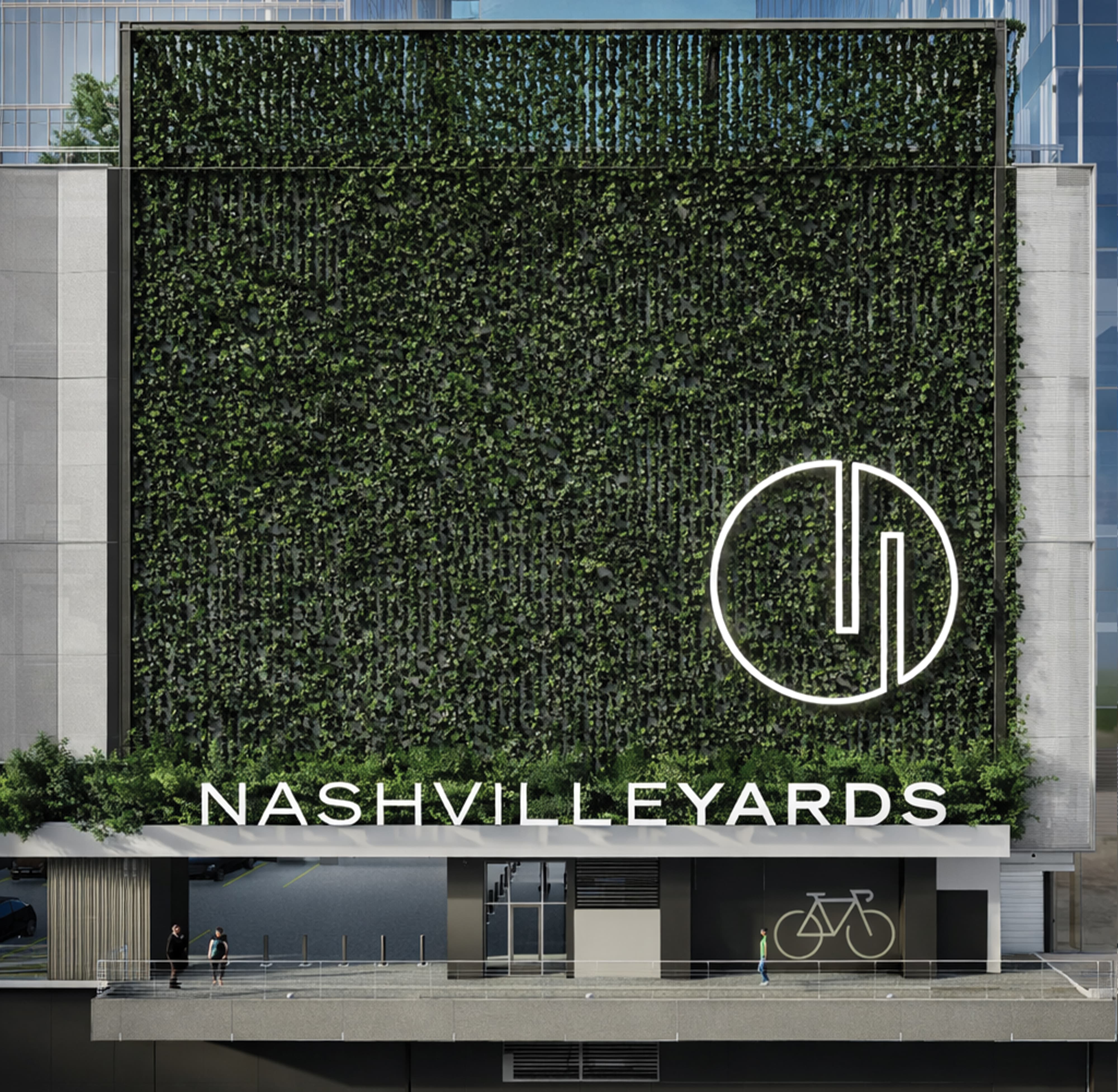 Architectural rendering of the Nashville Yards building exterior featuring a large-scale living green wall with a white illuminated circular logo mark and "Nashville Yards" channel letter signage at street level, showcasing experiential graphics, placemaking, and master sign program design for a mixed-use development by RSM Design.