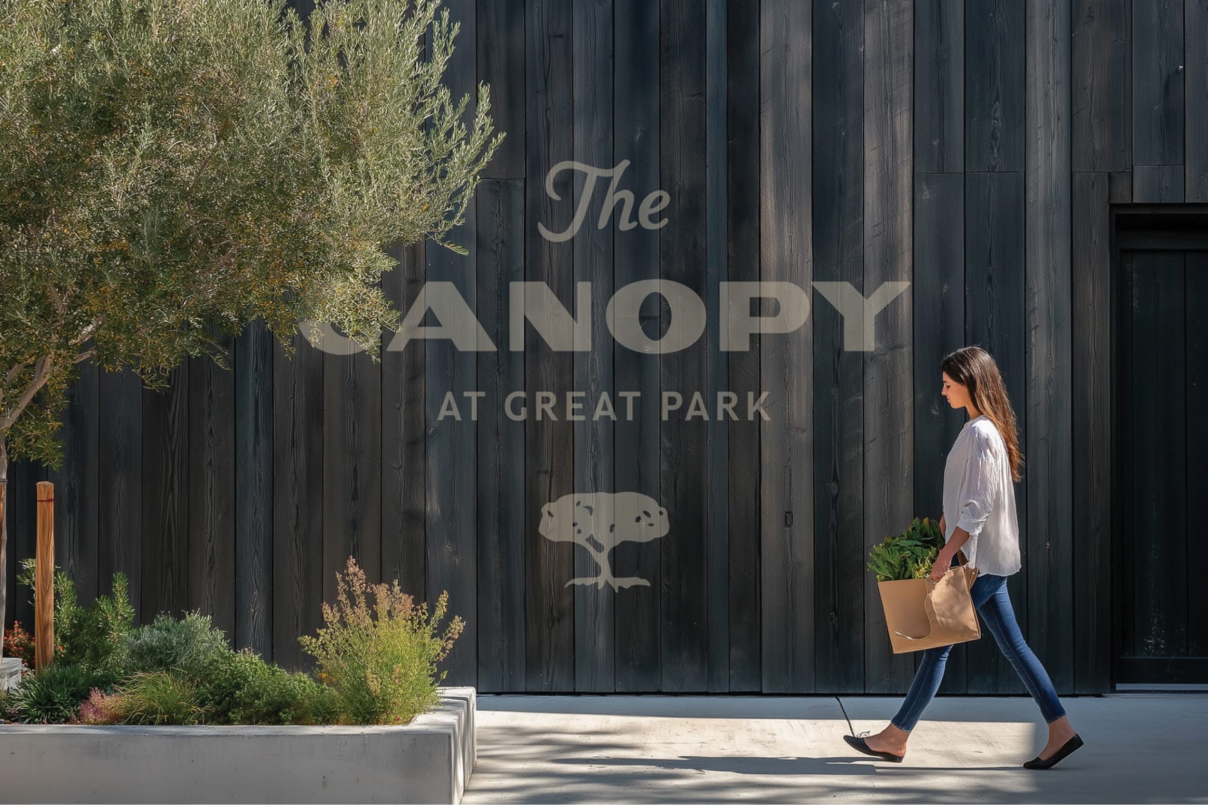 The Canopy at Great Park brand identity and tree logo painted on charred wood facade - environmental graphic design by RSM Design