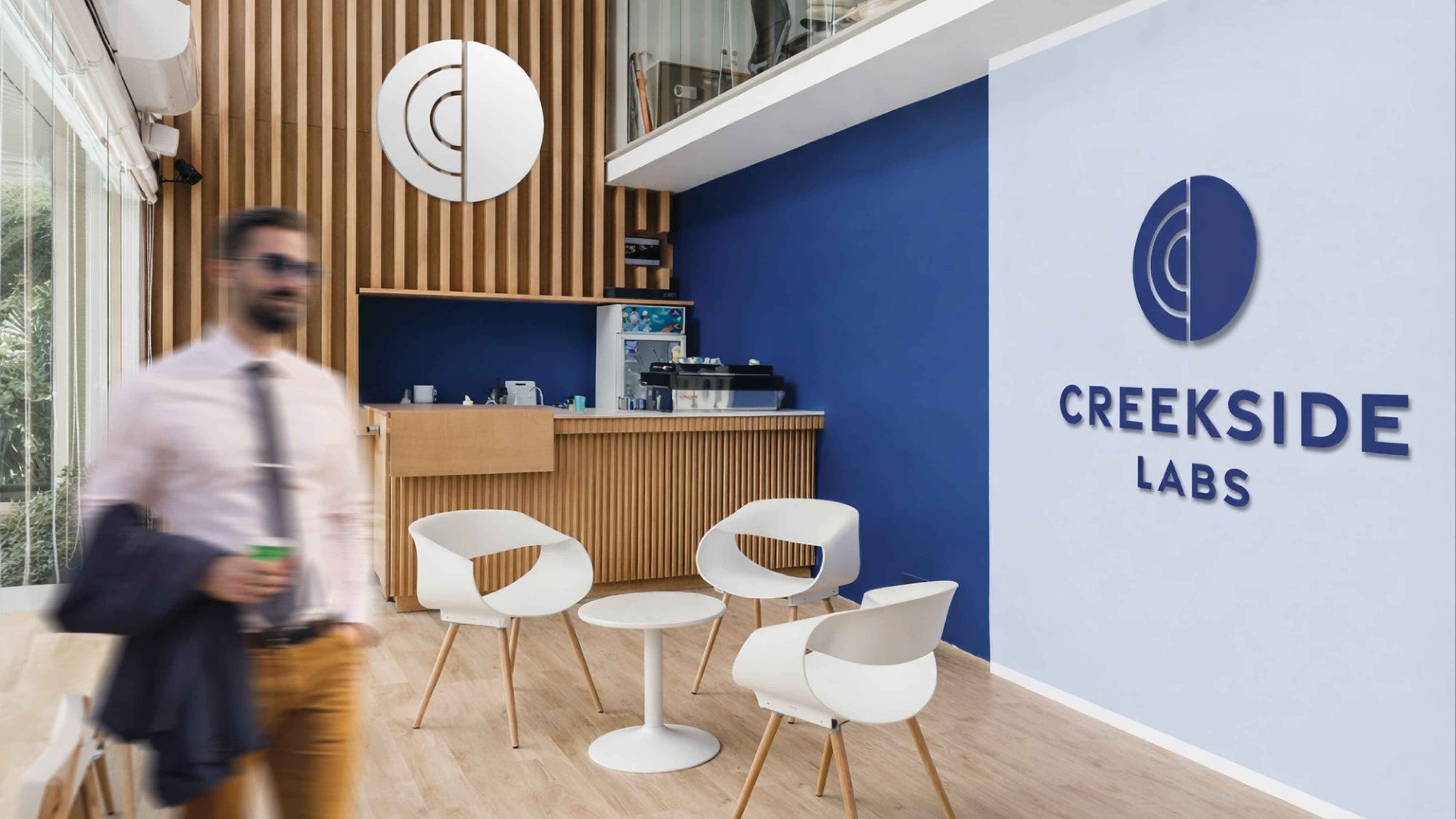 Corporate interior environment featuring Creekside Labs branded wall signage and logo, illustrating environmental graphic design, brand identity integration, and workplace placemaking within a corporate and innovation campus setting.