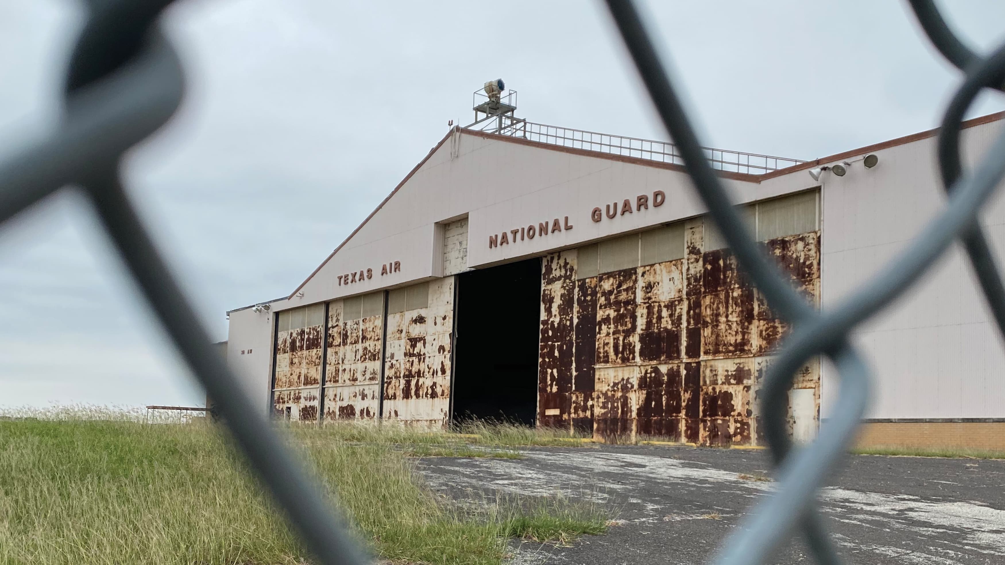 An old hangar at Hensley Field with Texas Air National Guard signage on the front