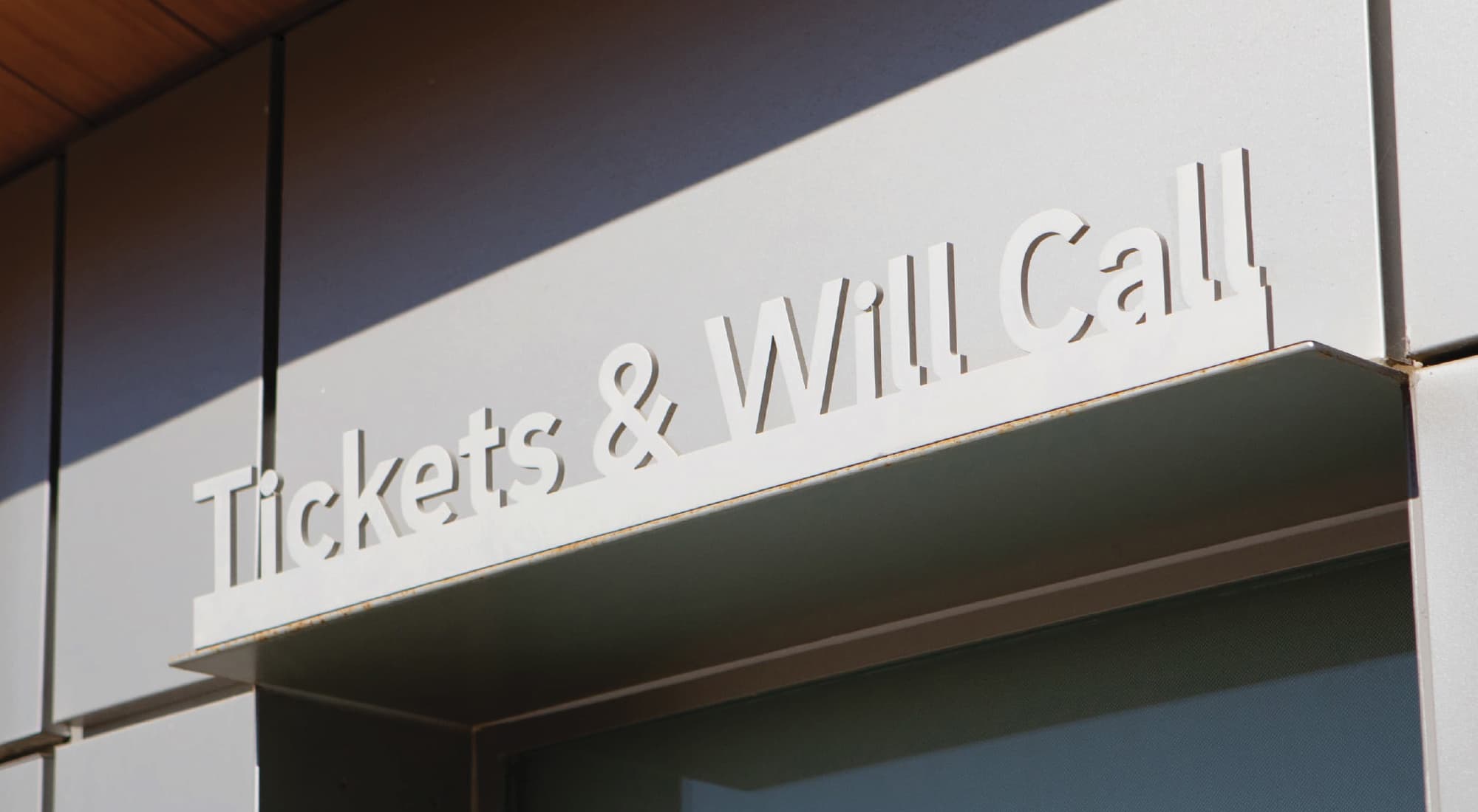 Tickets and Will Call signage integrated into building facade, demonstrating environmental graphic design, signage systems, and wayfinding for a sports and entertainment venue within a mixed-use destination by RSM Design